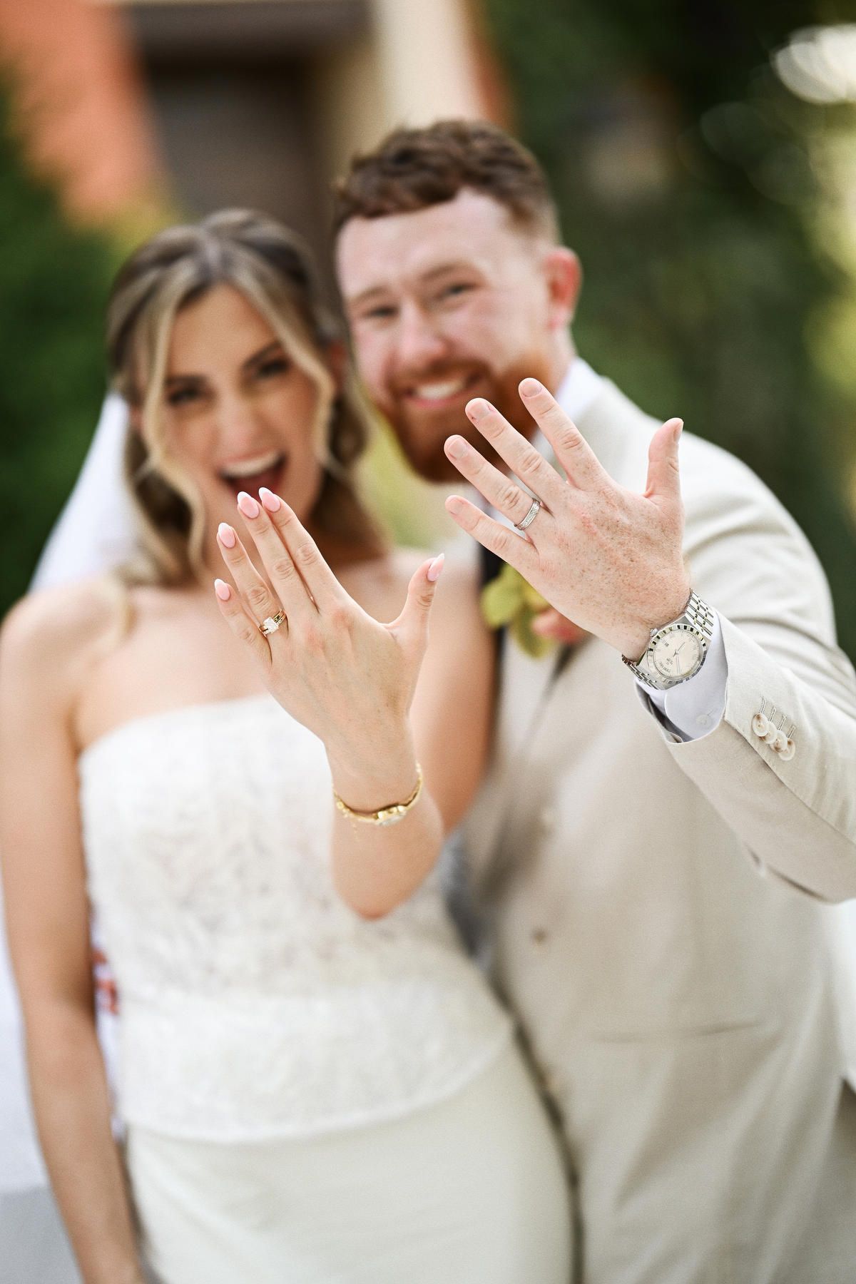 Happy newlyweds showcasing their wedding rings and smiling. Beautiful bridal details and joyful moments captured by Darista Wedding.