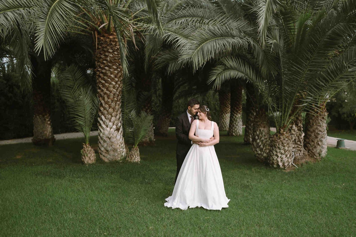 Romantic couple walk through the lush Mediterranean gardens of Mas d’Alzedo, Valencia