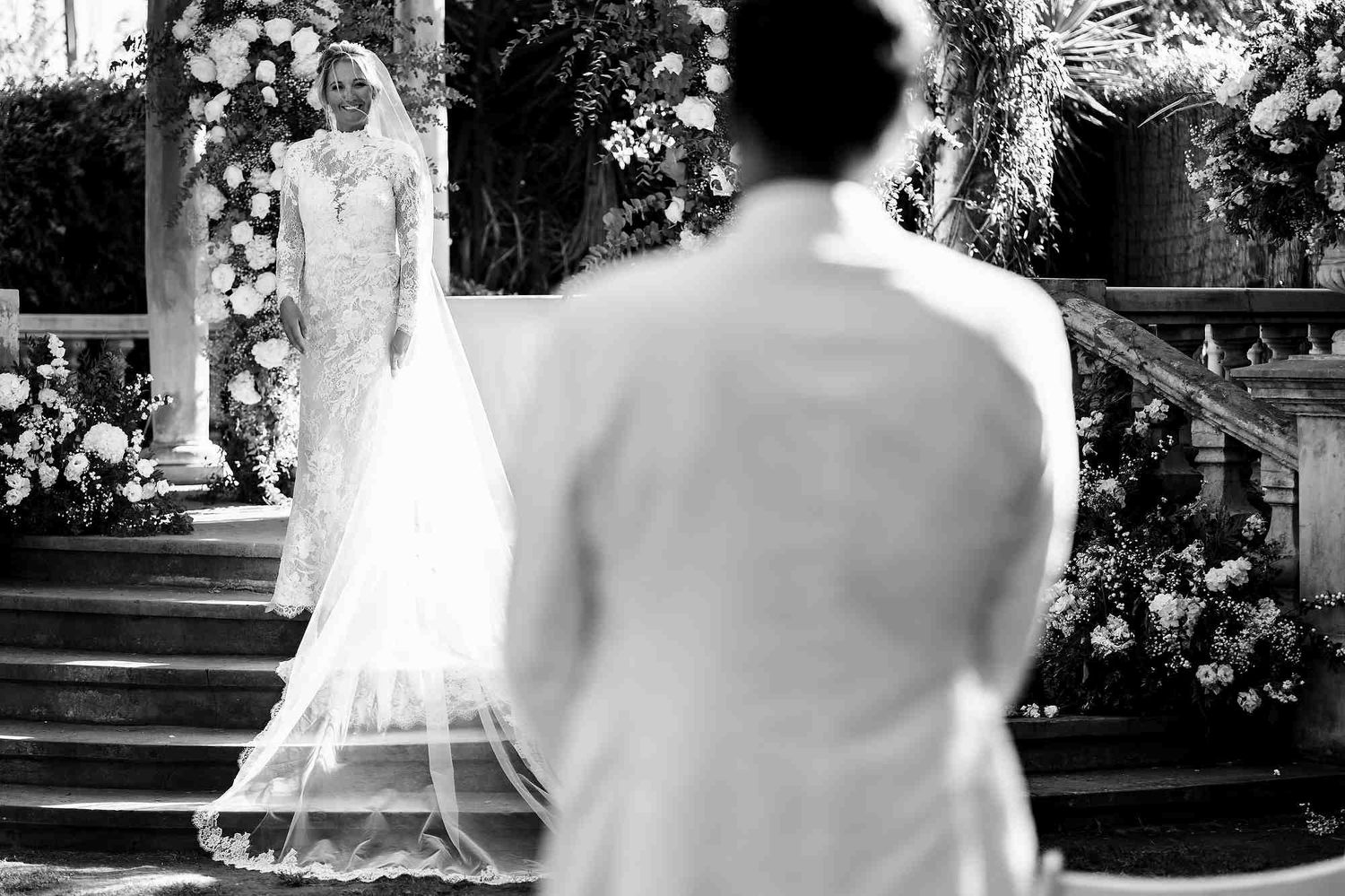 The emotional moment of the groom looking at his bride as she approaches the ceremony altar at Casa Santonja.