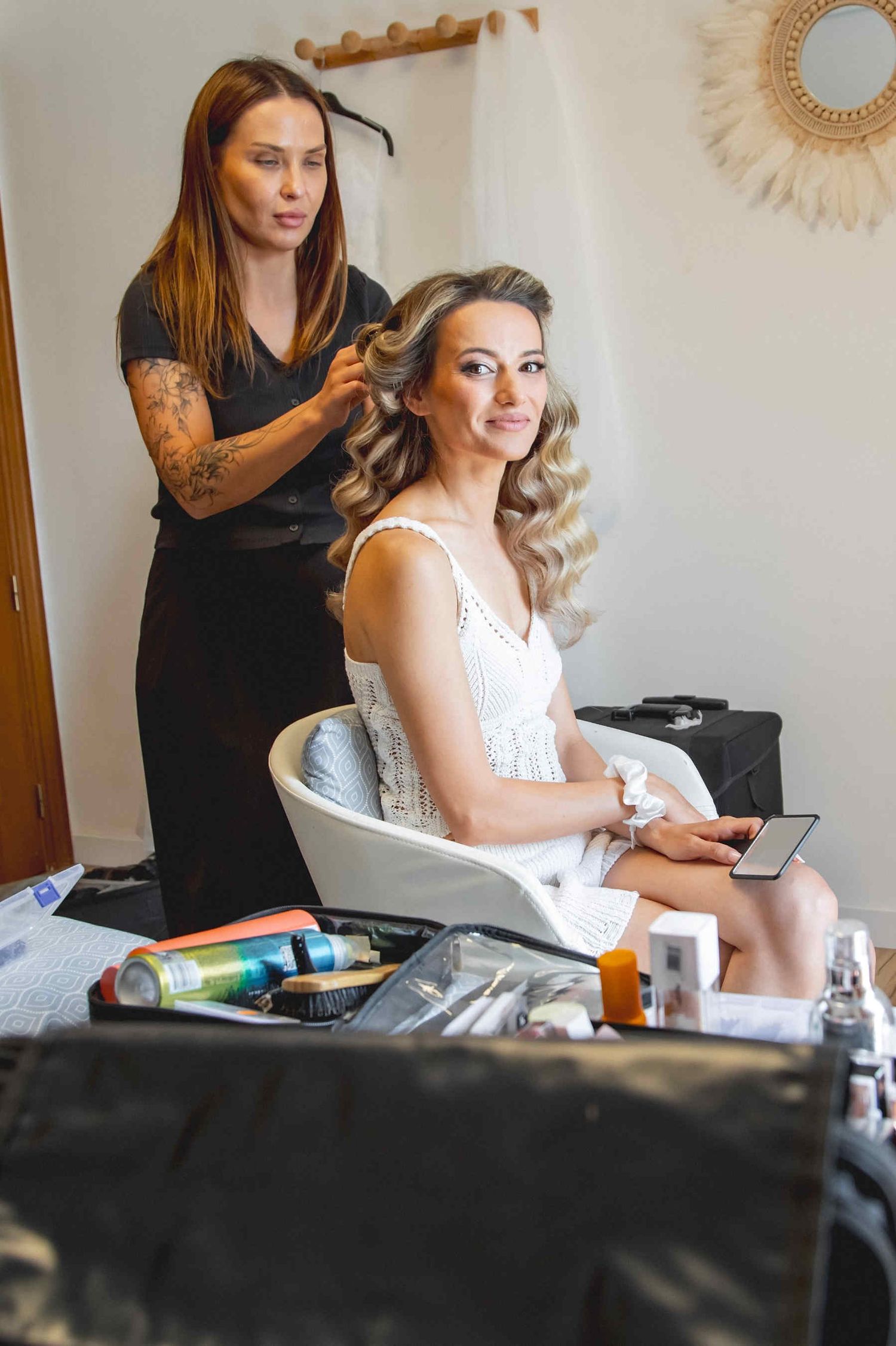 A bride getting ready in the luxury suites of Huerto San Rafael, enjoying professional mobile makeup and hair services.