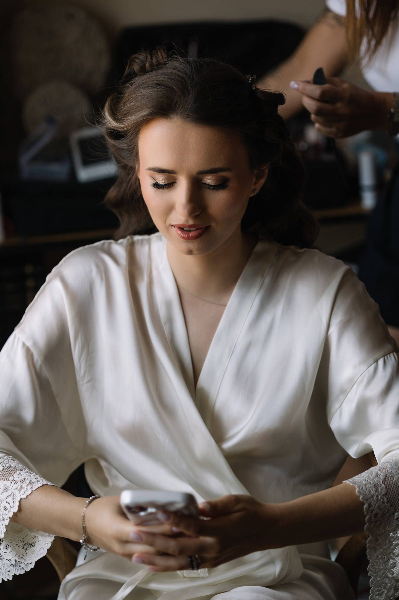 Stylist adjusting the bride's hair in the boudoir of Alqueria del Xúquer, ensuring a flawless look for a Spanish countryside wedding.