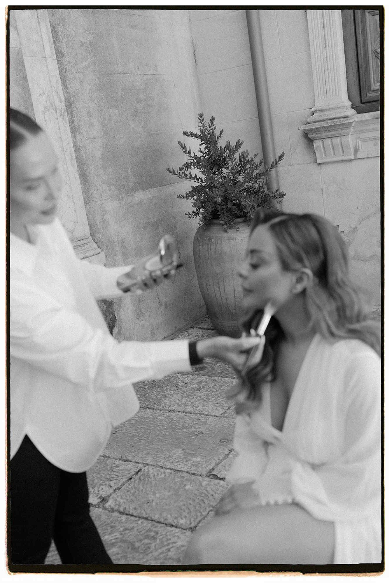 Final wedding makeup touches for the bride at Finca Torrefiel. Professional beauty preparation before putting on the bridal gown.