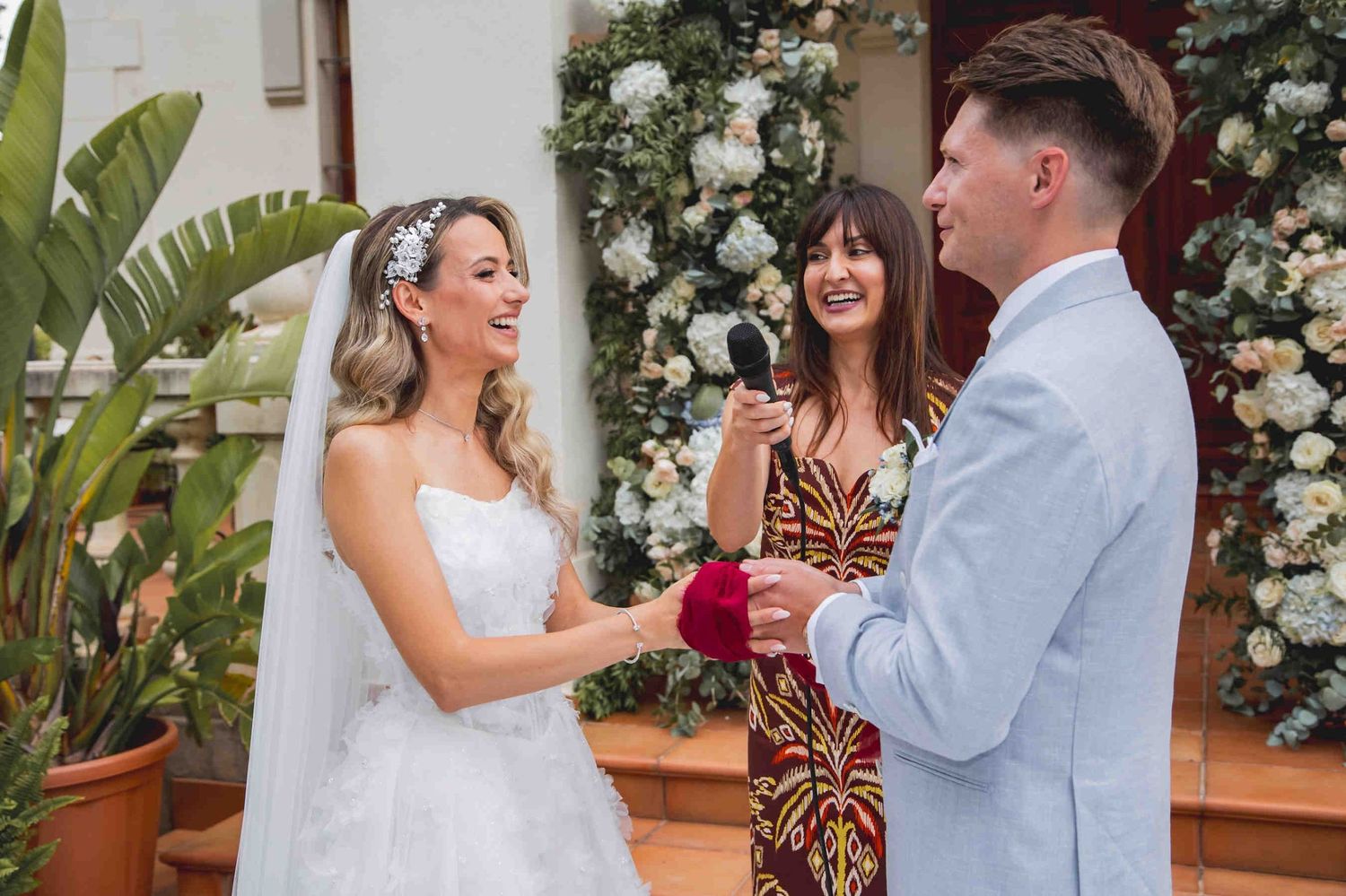 Romantic wedding couple portrait at the grand entrance of Huerto San Rafael estate in Valencia, Spain.