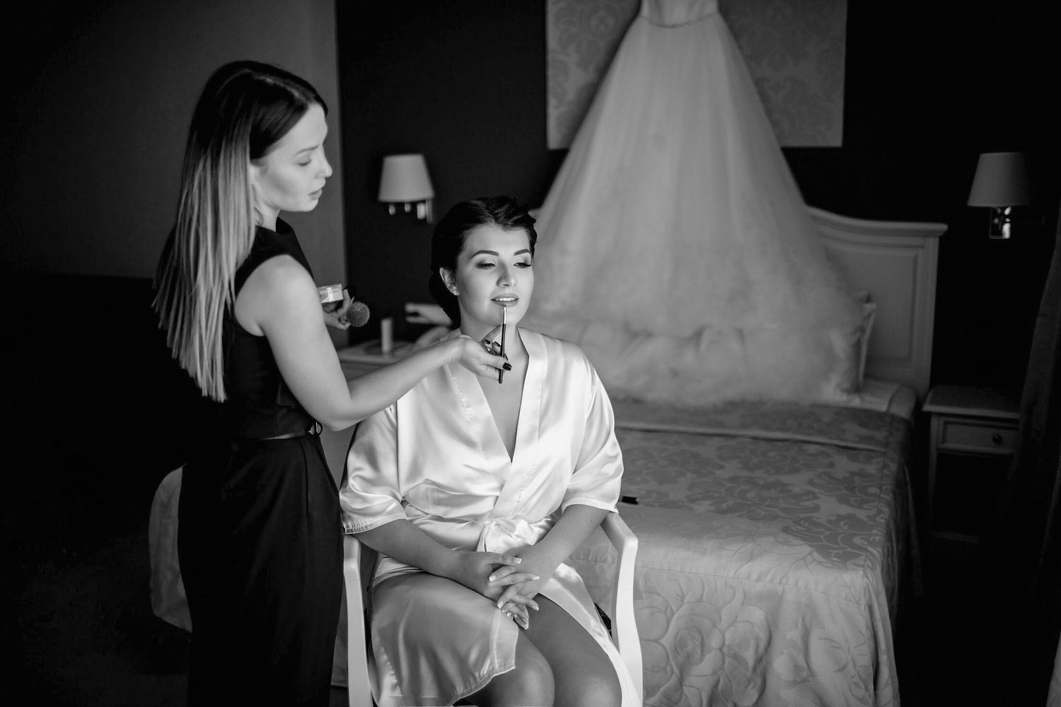 Professional makeup artist and hair stylist creating a luxury bridal look for a destination wedding in Europe. High-end beauty services.