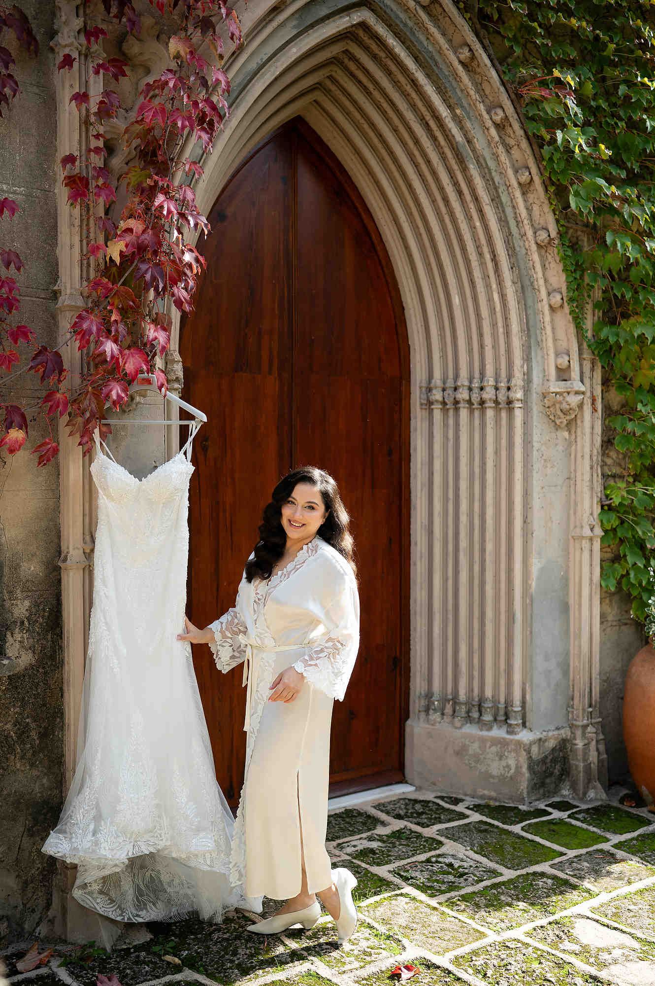 A bride during her morning preparation at Casa Santonja, showing her finished hair and makeup against the historic gates
