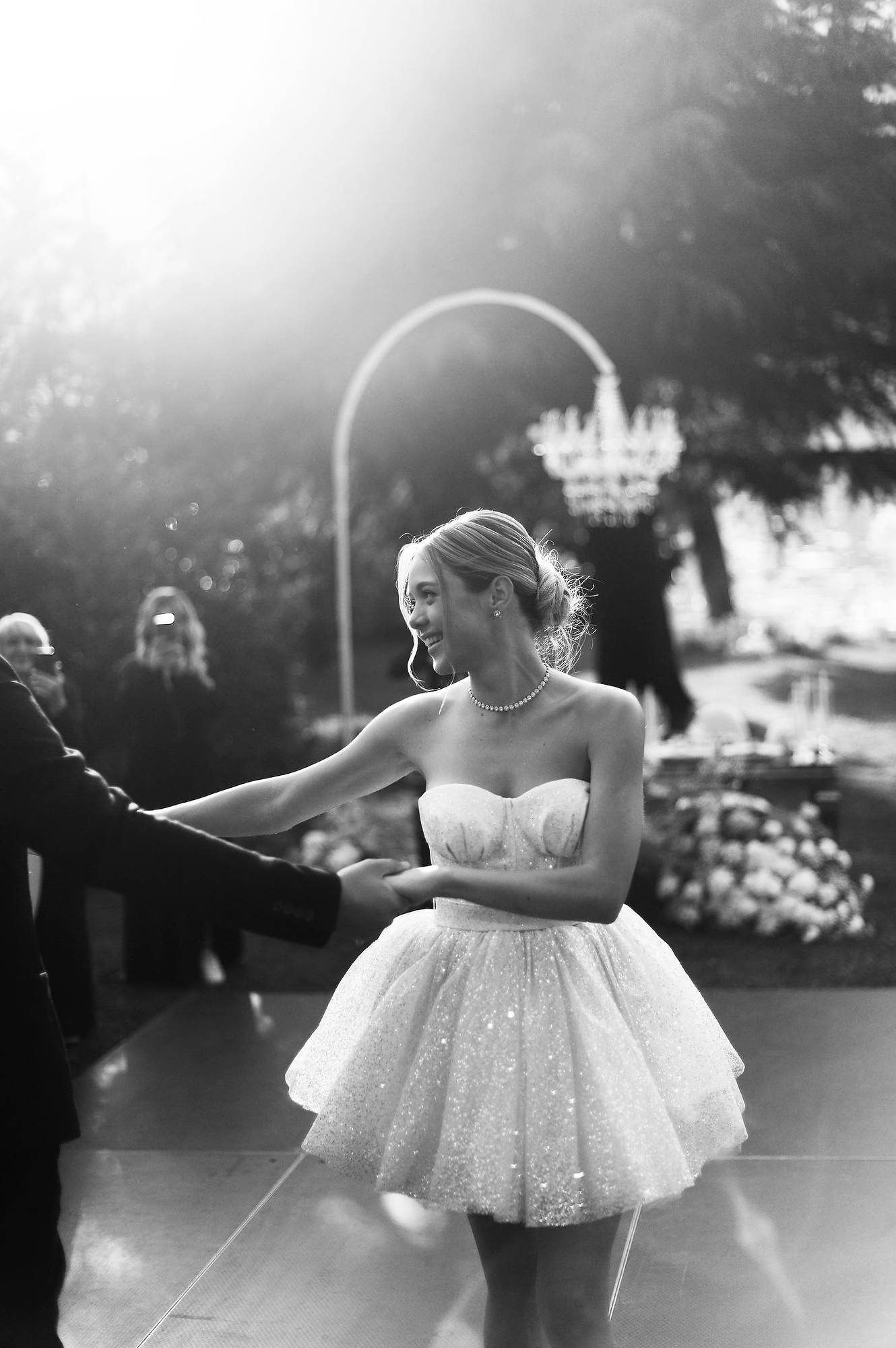 The bride’s second look for the evening: a stylish short wedding dress for dancing and the reception party at a Lake Como villa.