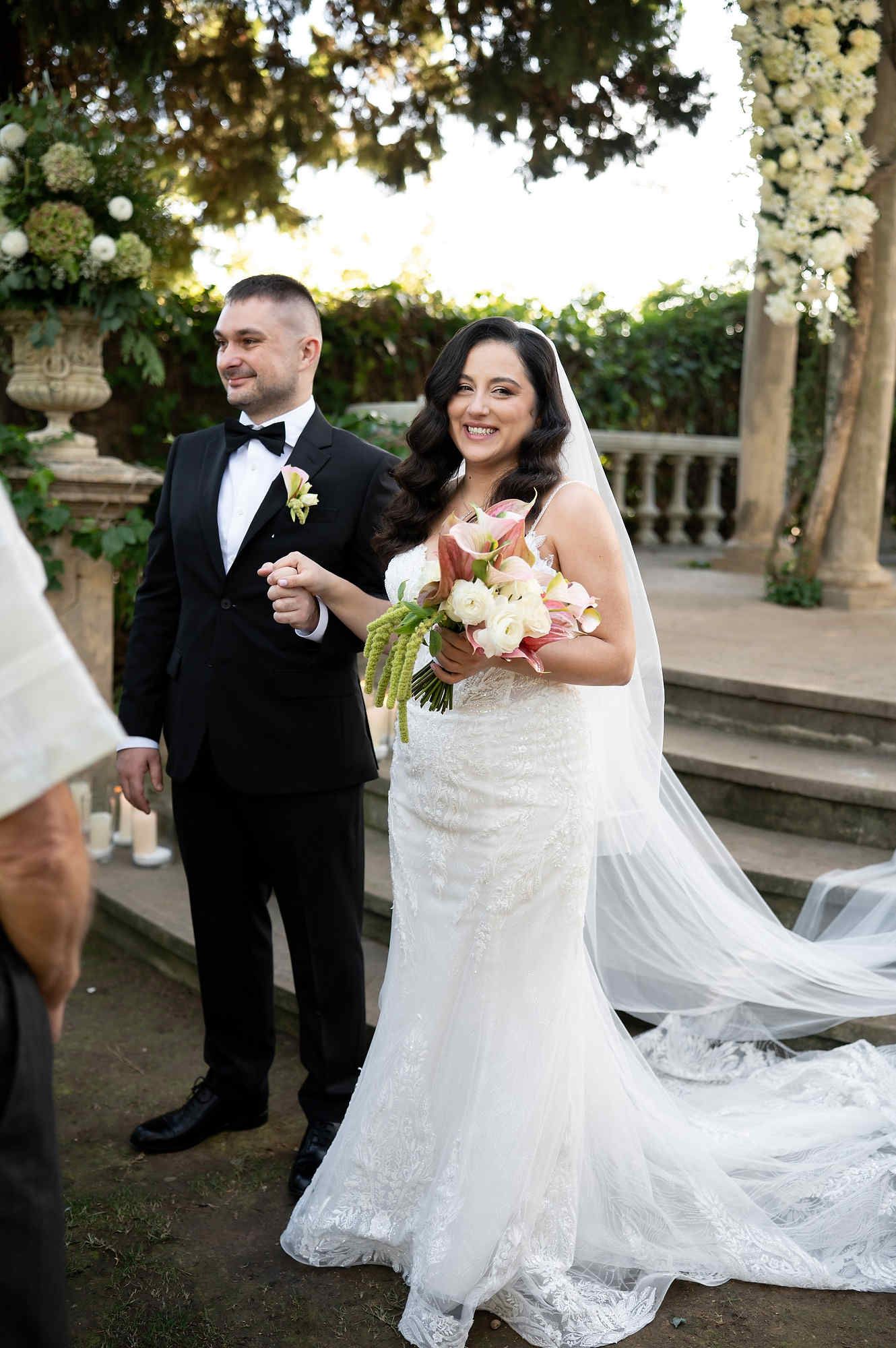 The happy newlyweds walking towards their guests for the celebration after the wedding ceremony at Casa Santonja