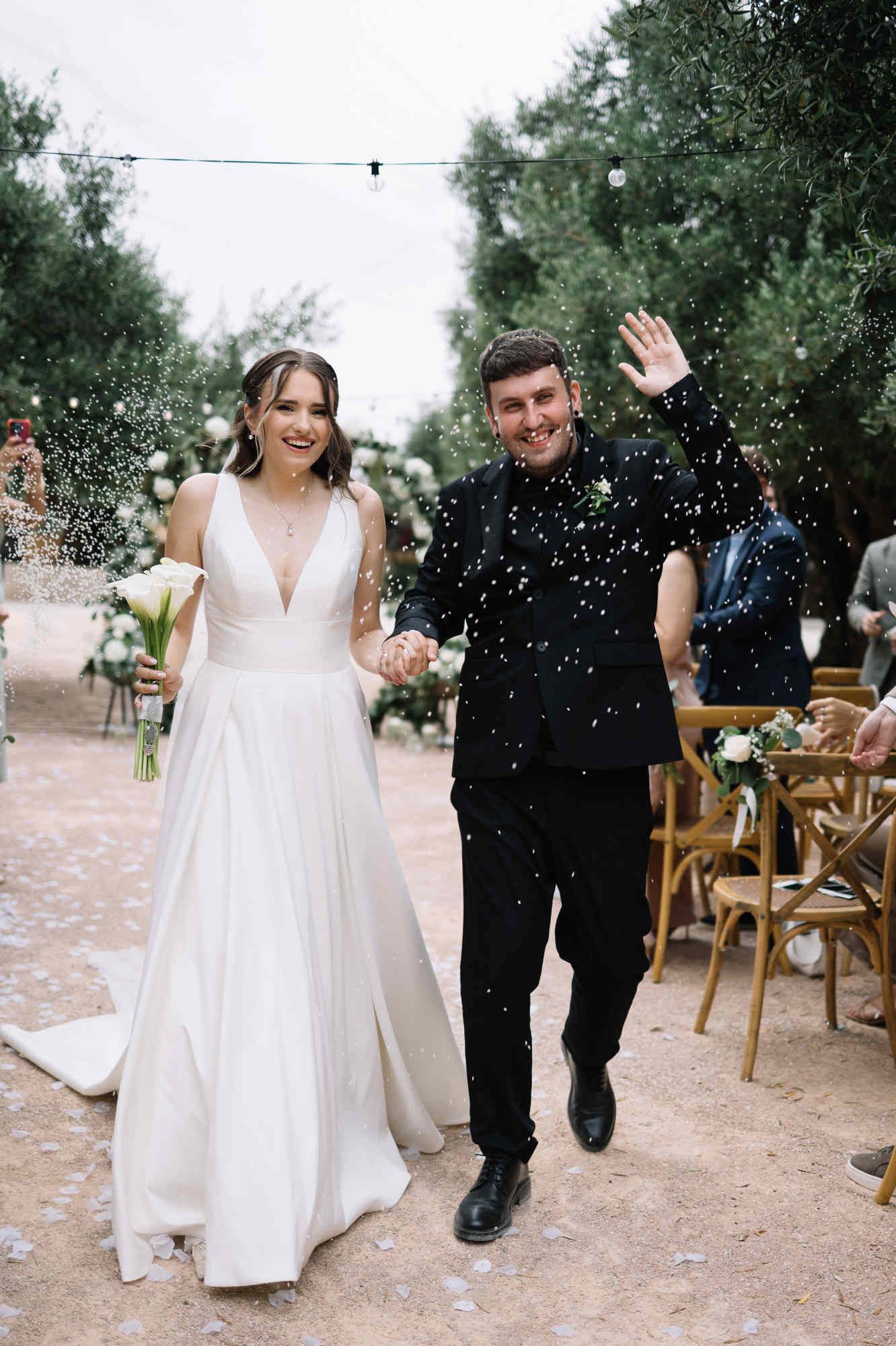 Radiant and happy newlyweds smiling together right after their wedding ceremony in the beautiful Spanish countryside near Valencia.
