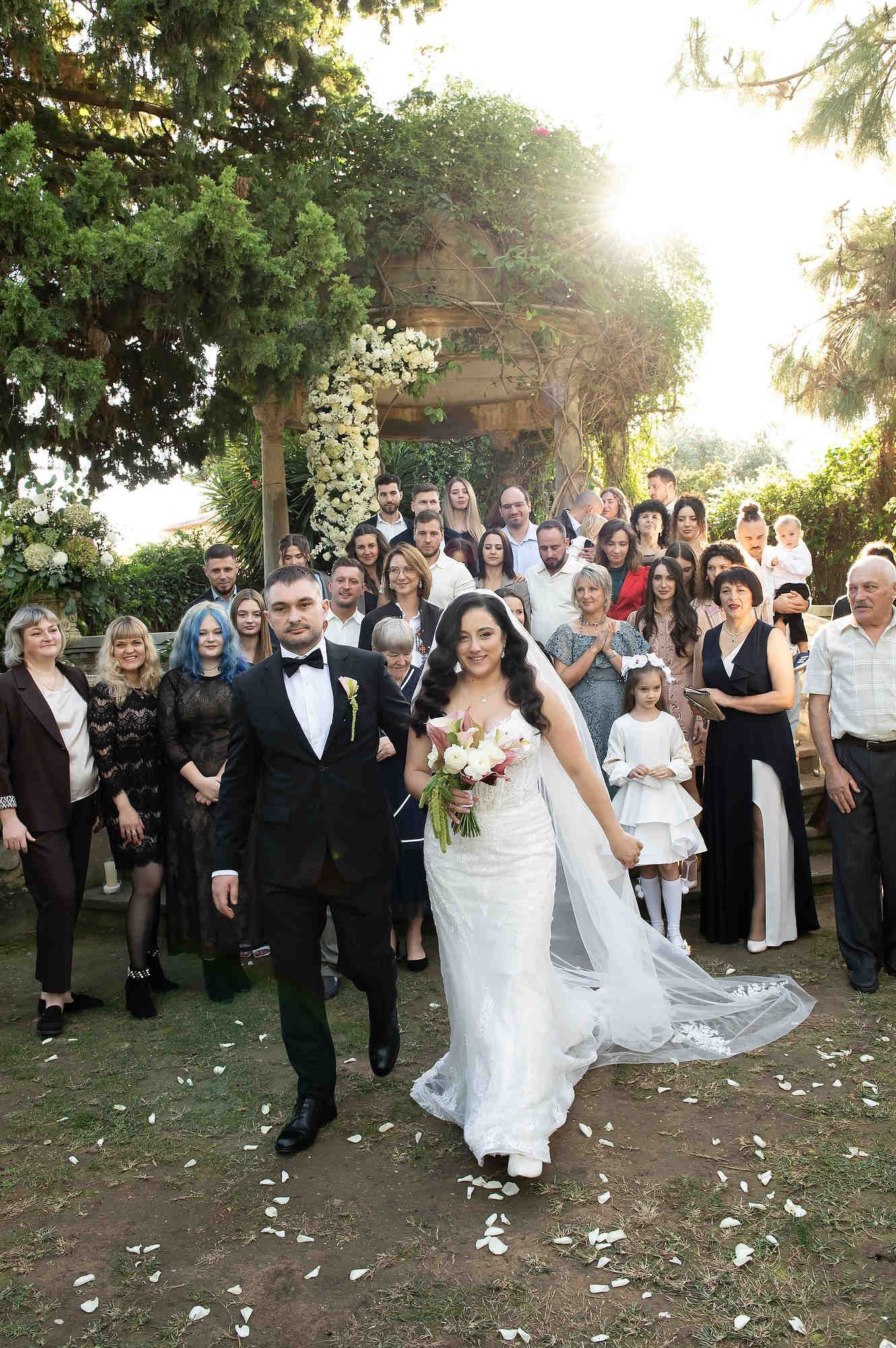 The happy newlyweds walking with guests for the celebration after the wedding ceremony in Valencia
