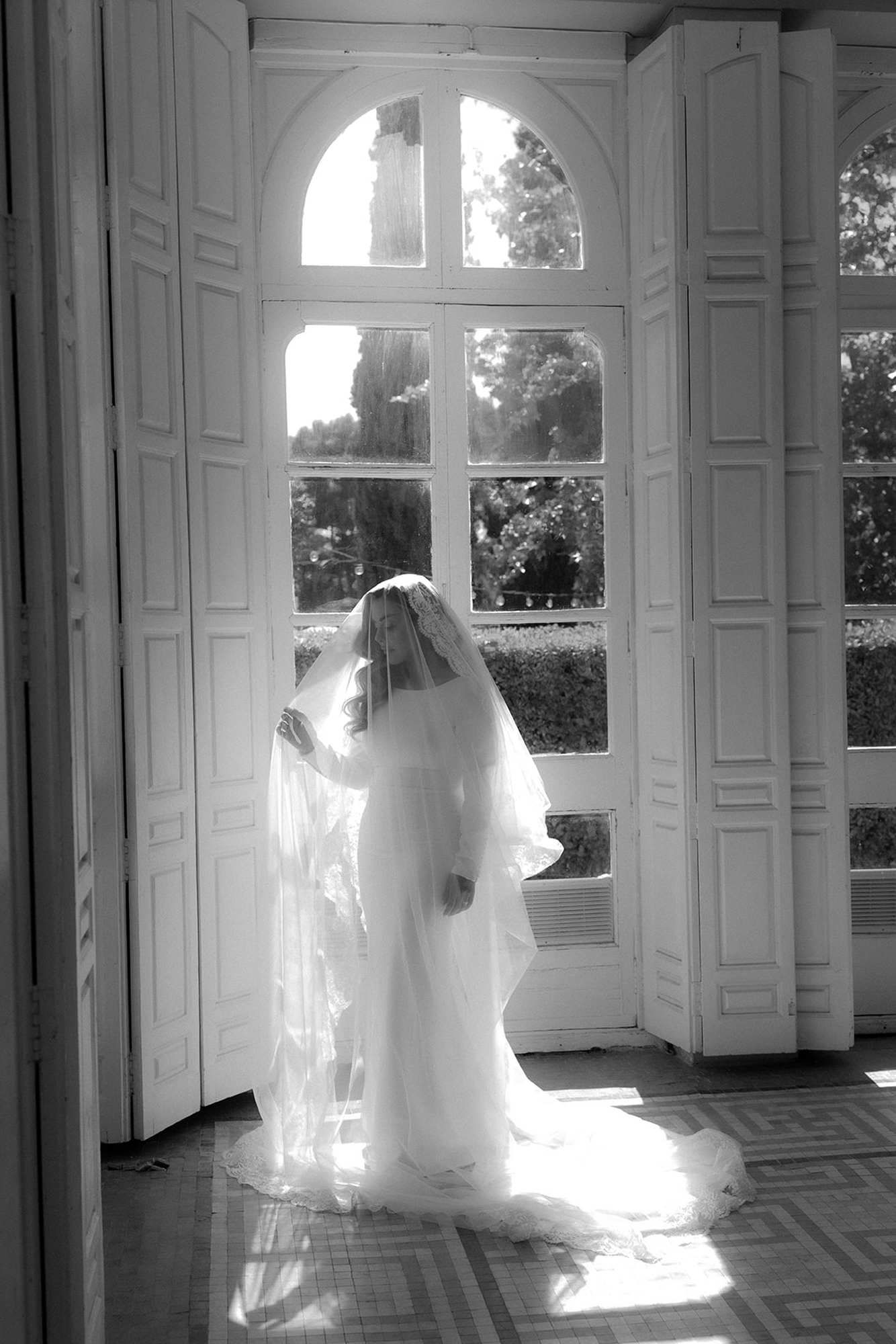 Sun-drenched fashion editorial bridal look at Finca Torrefiel. Complete wedding hair and makeup glowing in the window light.