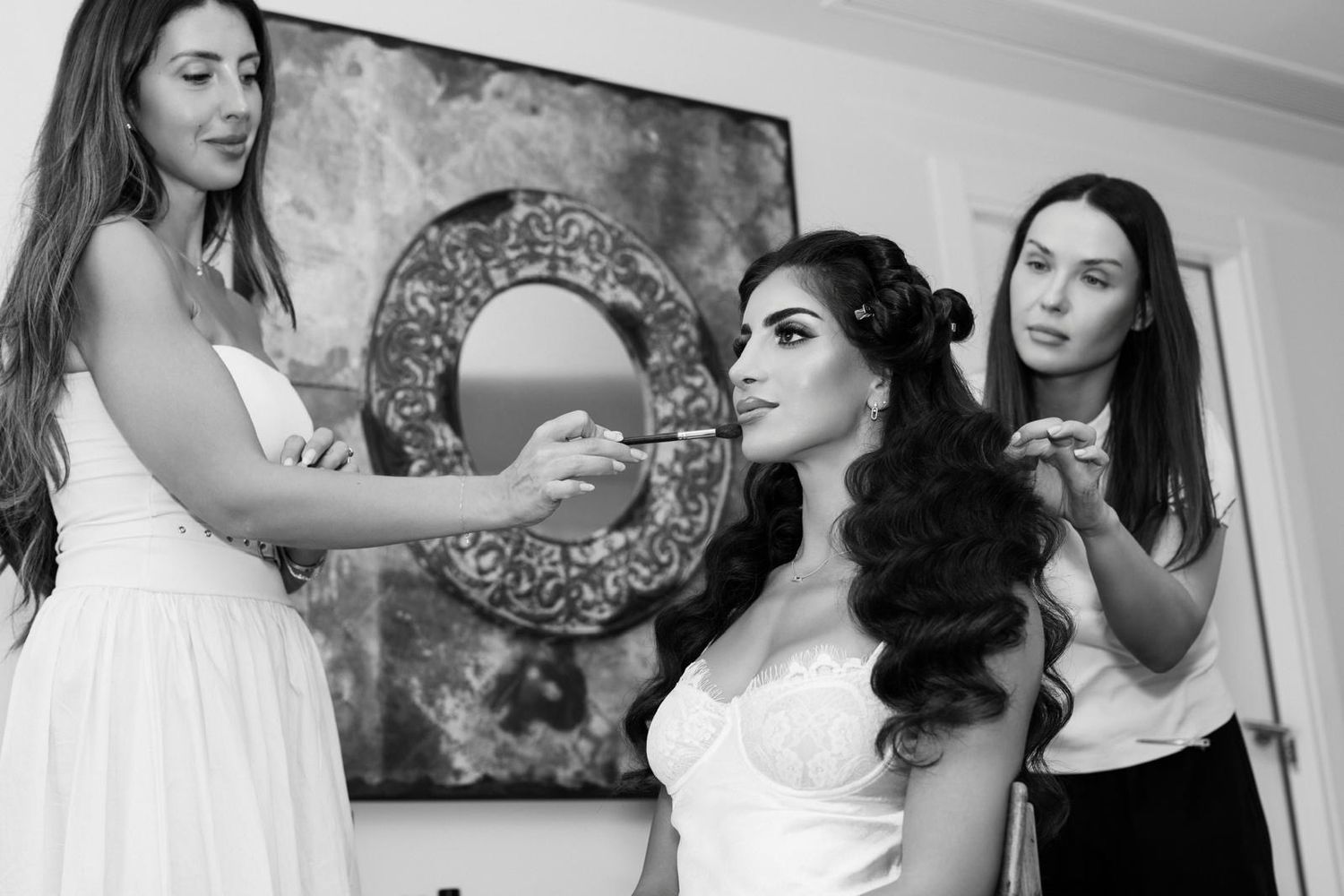 Anastasia Larionova creating flawless Hollywood waves for the bride during her getting-ready session in a suite at the luxury ME Ibiza hotel