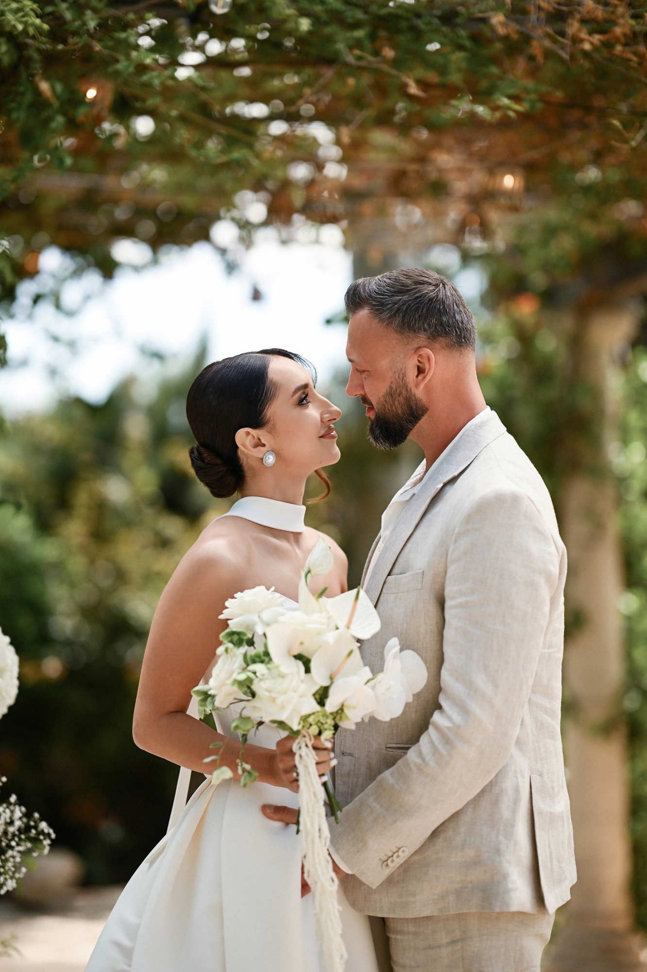 Happy newlyweds looking at each other at Villa Paula, showcasing the bride's flawless wedding makeup and elegant hairstyle.