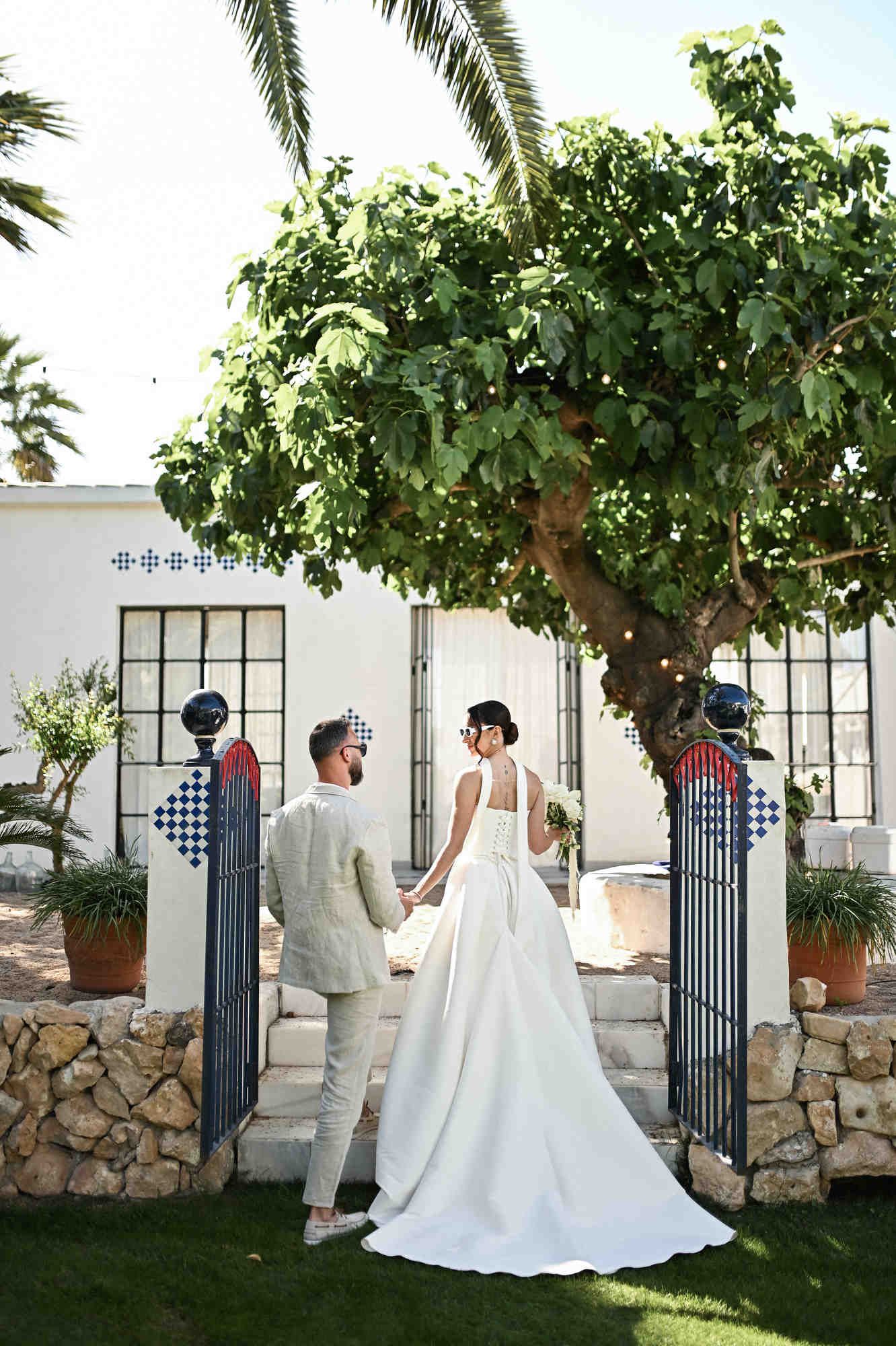 Wedding photoshoot of the couple surrounded by lush Mediterranean greenery at Villa Paula, showing full bridal hair and makeup.