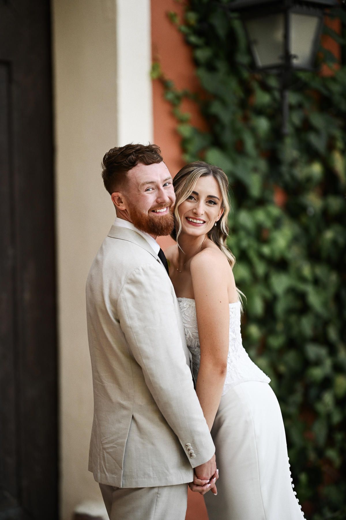 Romantic wedding portrait of a bride and groom looking into the camera. Flawless wedding makeup and hair design glowing in Valencia.