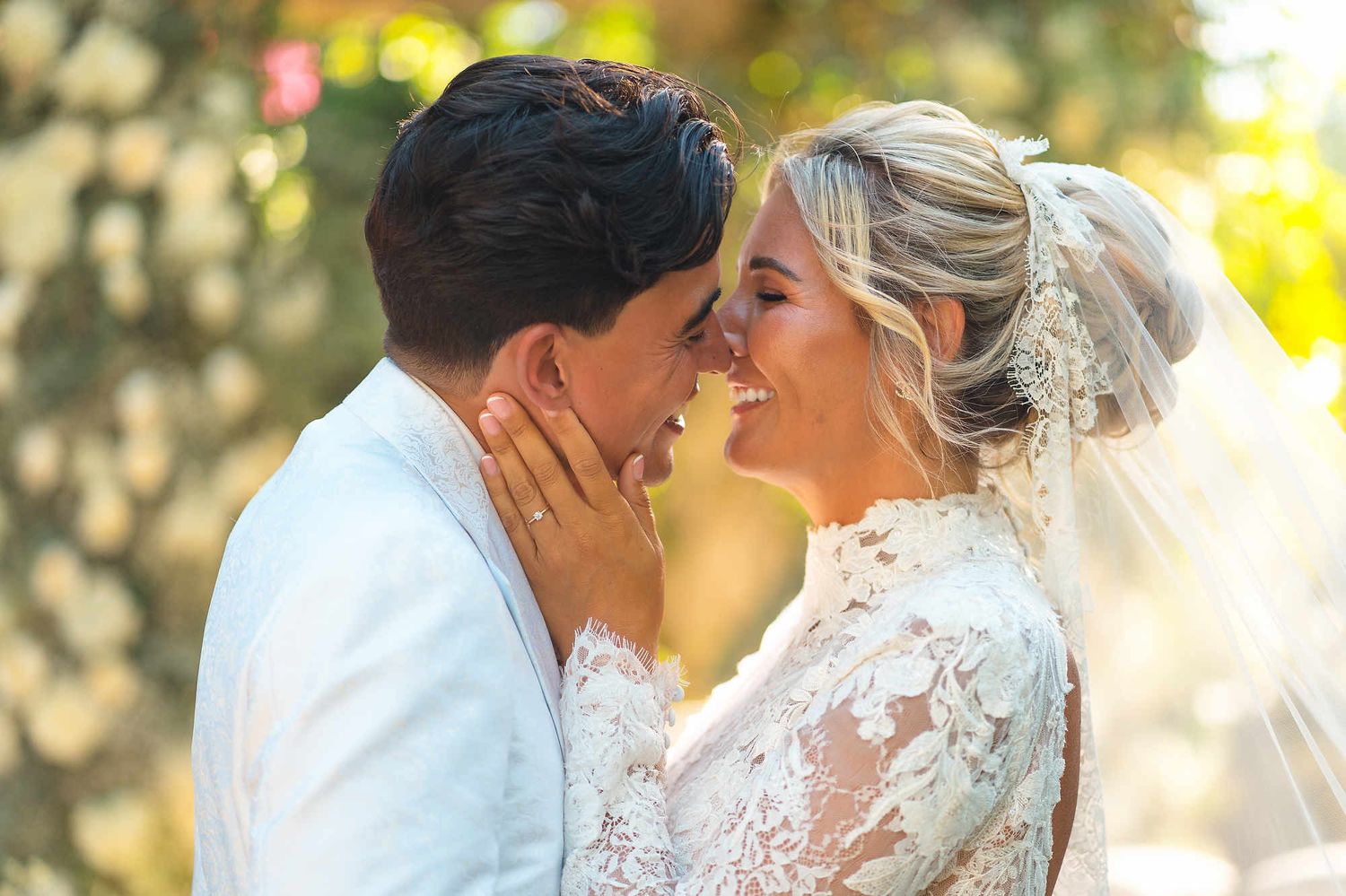 Close-up portrait of a smiling bride and groom, highlighting their genuine emotions and professional bridal beauty look.