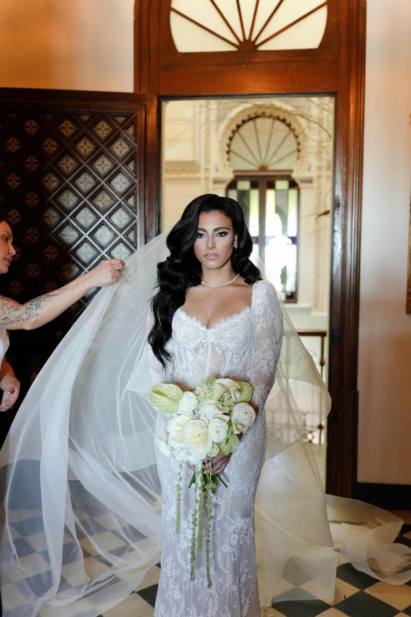 Professional makeup artist Anastasia Larionova applying final touches to the bride's elegant beauty look at Gran Villa Rosa mansion