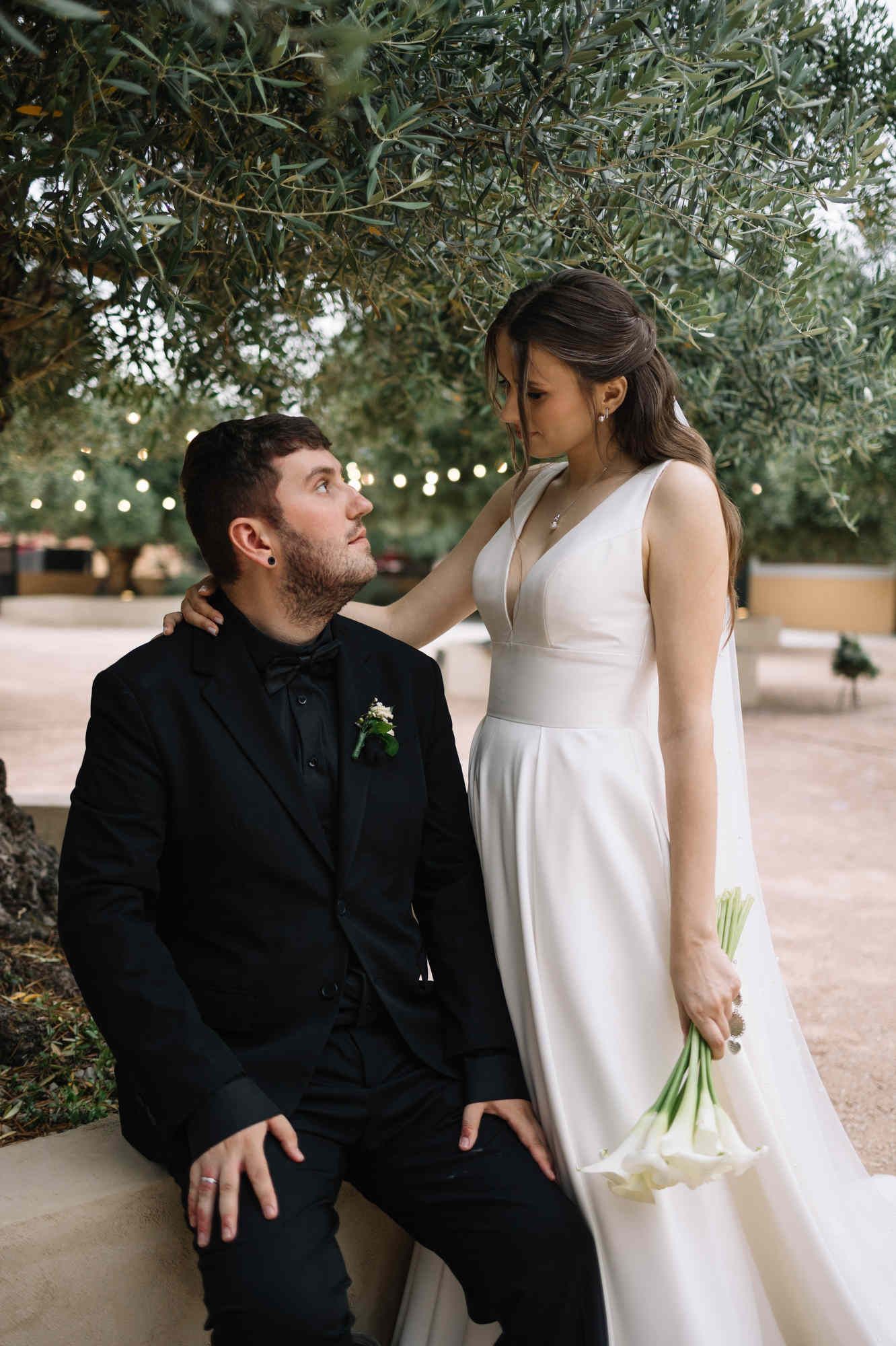 Bride looking lovingly at her groom during a romantic wedding photoshoot in the lush Mediterranean gardens of Alqueria del Xúquer.