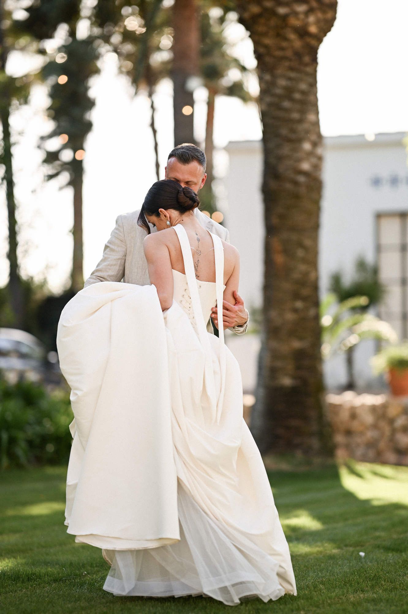 Bride and groom sharing a touching and emotional embrace while dancing their first dance at Villa Paula wedding reception.