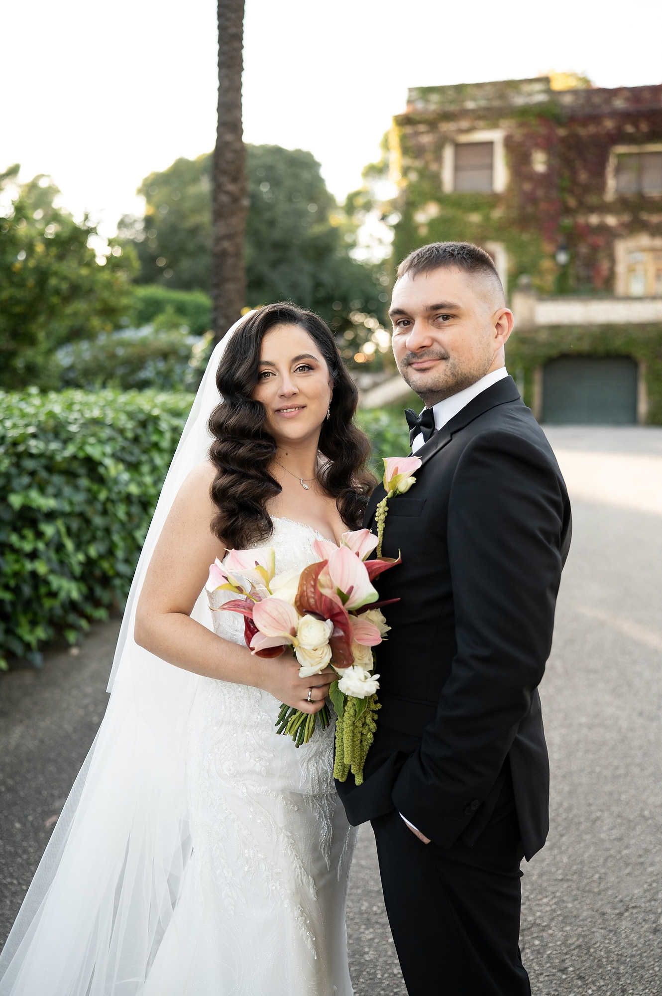 A classic wedding portrait of the couple looking at the camera during their photoshoot on the grand grounds of Casa Santonja