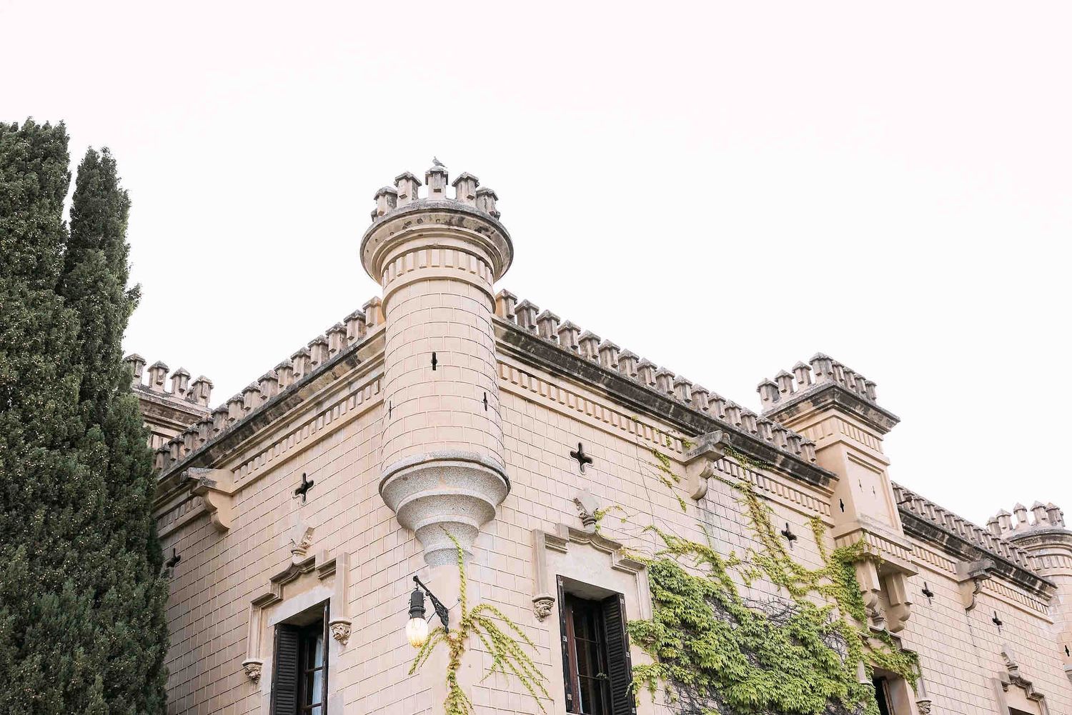 The grand architectural facade of Castell Jalpí, a premier 19th-century wedding venue near Barcelona, Spain.