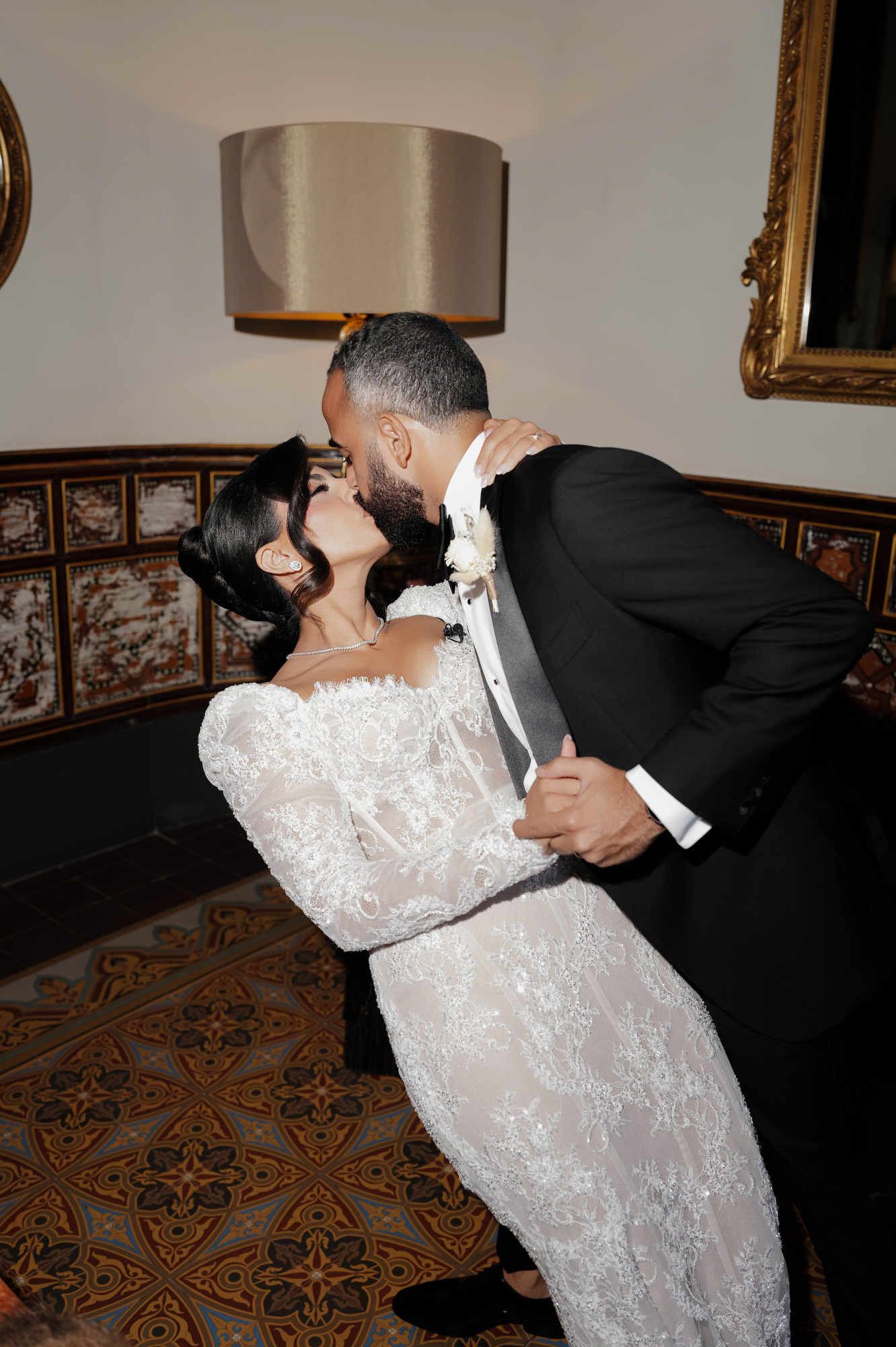 The groom kissing the bride, who features a second professional hairstyle specially created for the wedding banquet.