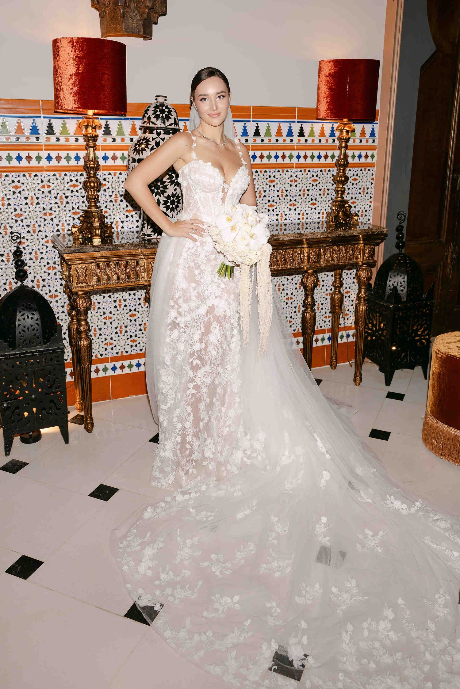 A regal bride standing on the iconic grand staircase of Gran Villa Rosa for a destination wedding photoshoot.
