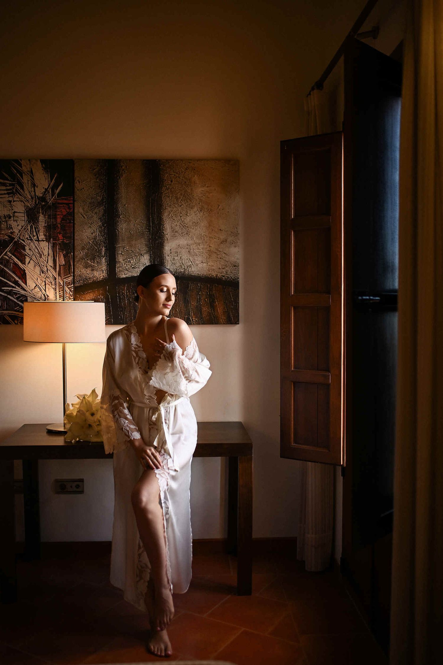 Bride after makeup in her boudoir at La Cartoixa d'Ara Christi. Editorial bridal styling in a luxury Valencia suite