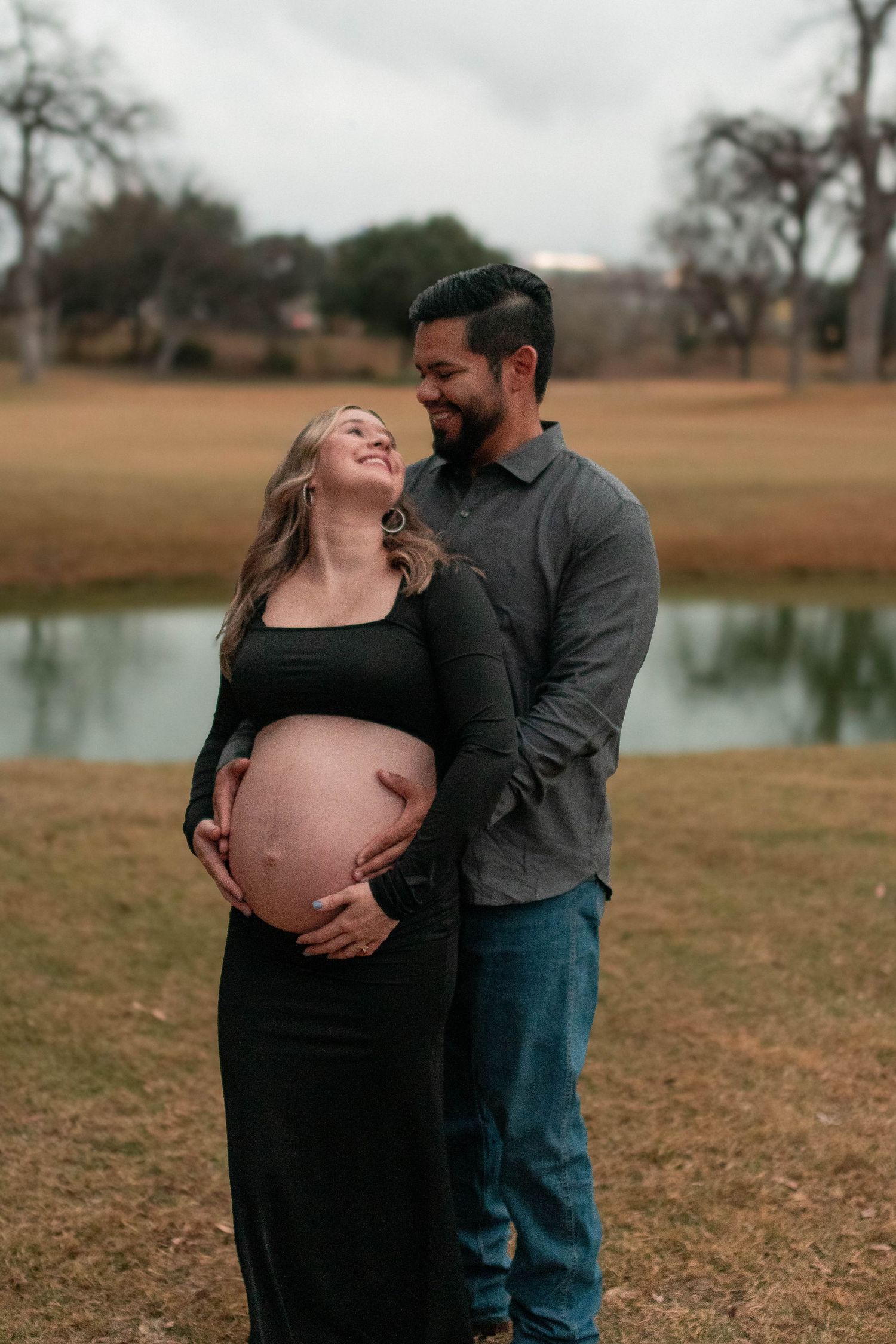 Candid maternity photos showing joyful moments between expectant parents outdoors.