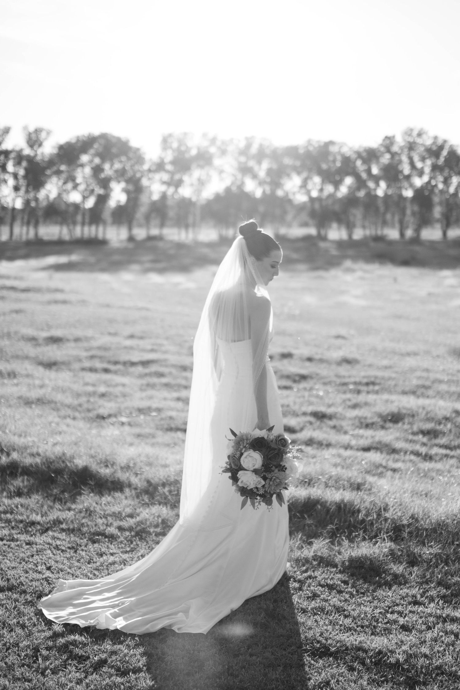 Black and white bridal portraits showing a flowing wedding dress and bouquet in a rustic outdoor setting.
