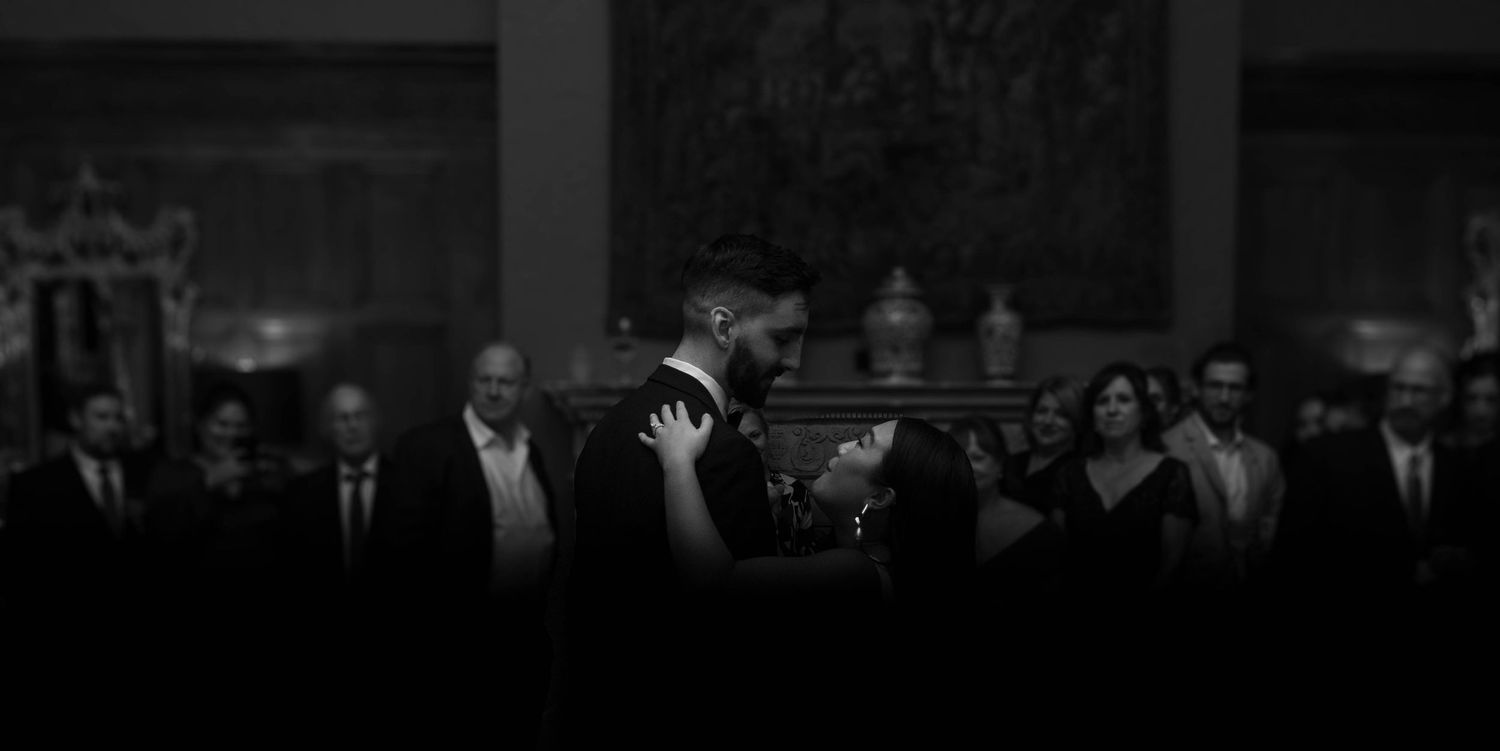 Dark silhouettes of a crowd against a dimly lit background.