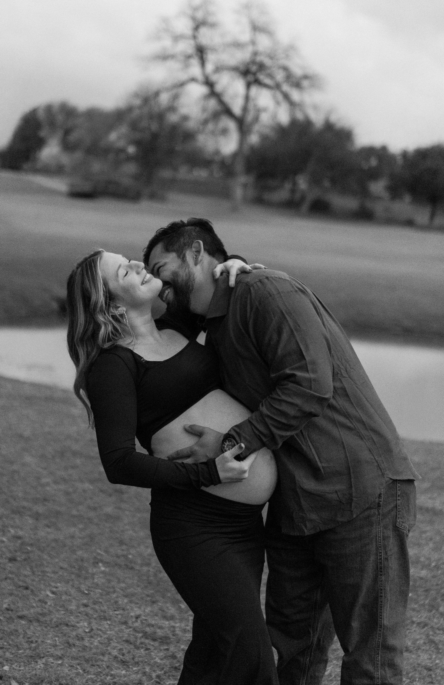 Romantic black and white maternity photos showing tender moments between partners.