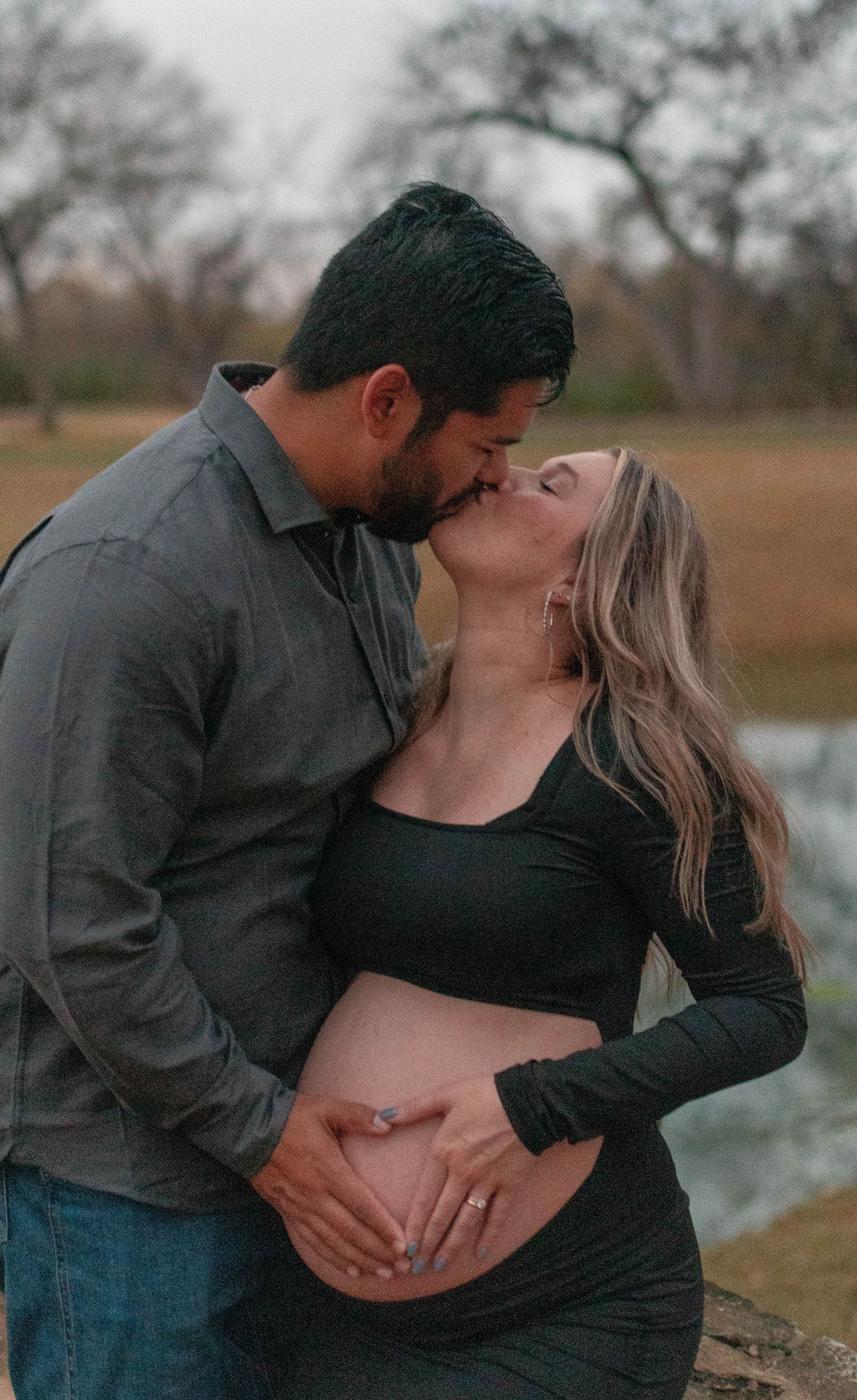 Romantic maternity photos showing tender moments between expectant couple.