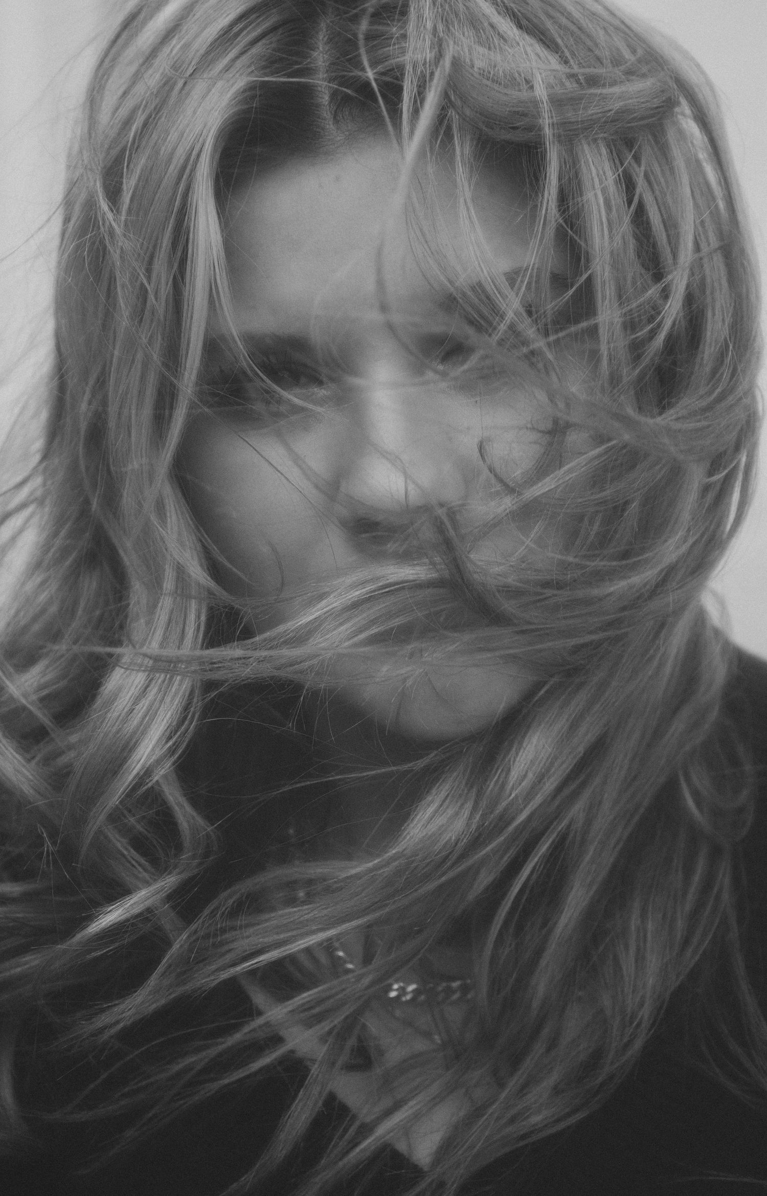 Artistic black and white series of windblown hair in motion.