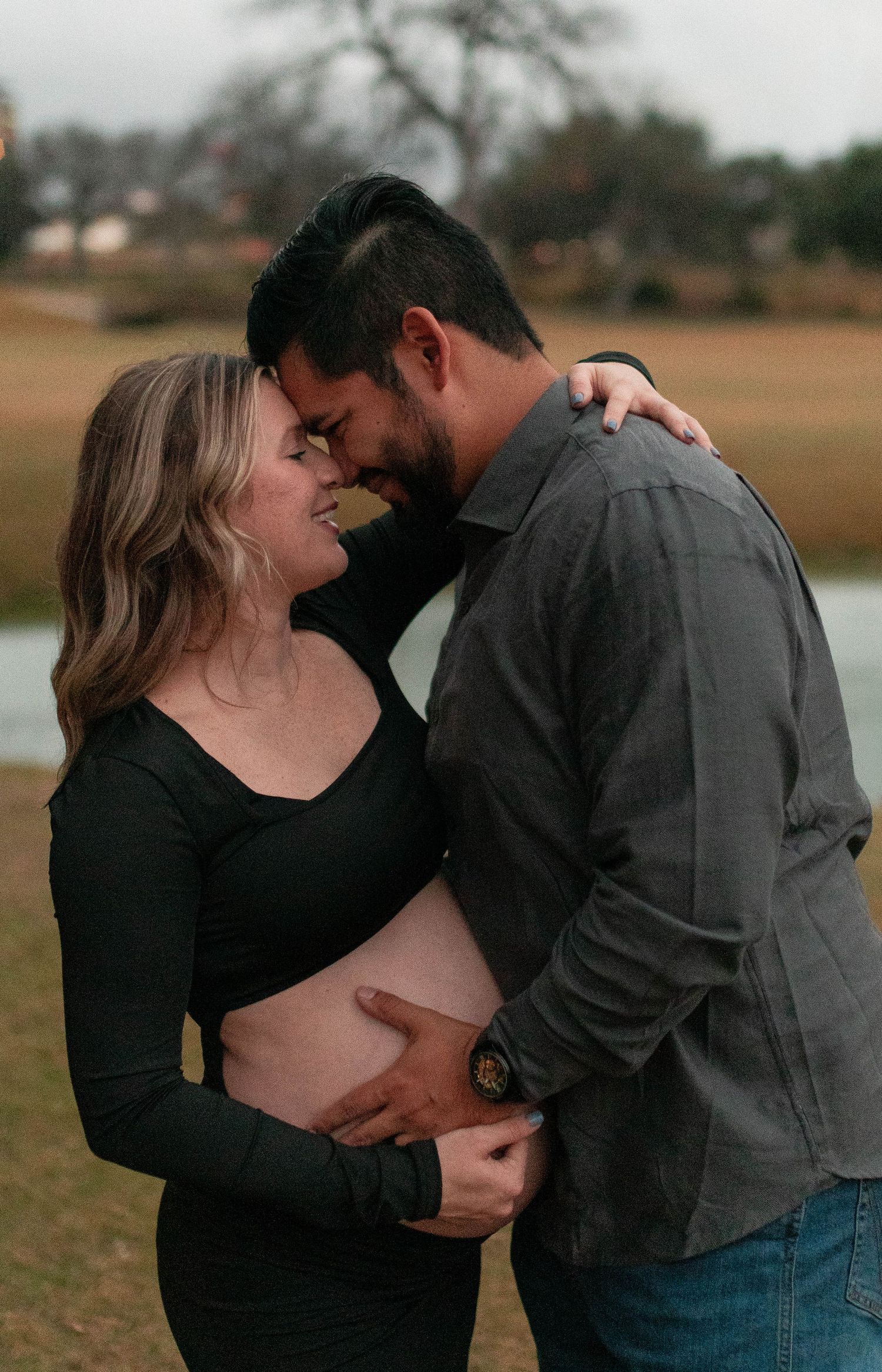 Emotional maternity photography capturing intimate moments between expectant parents.