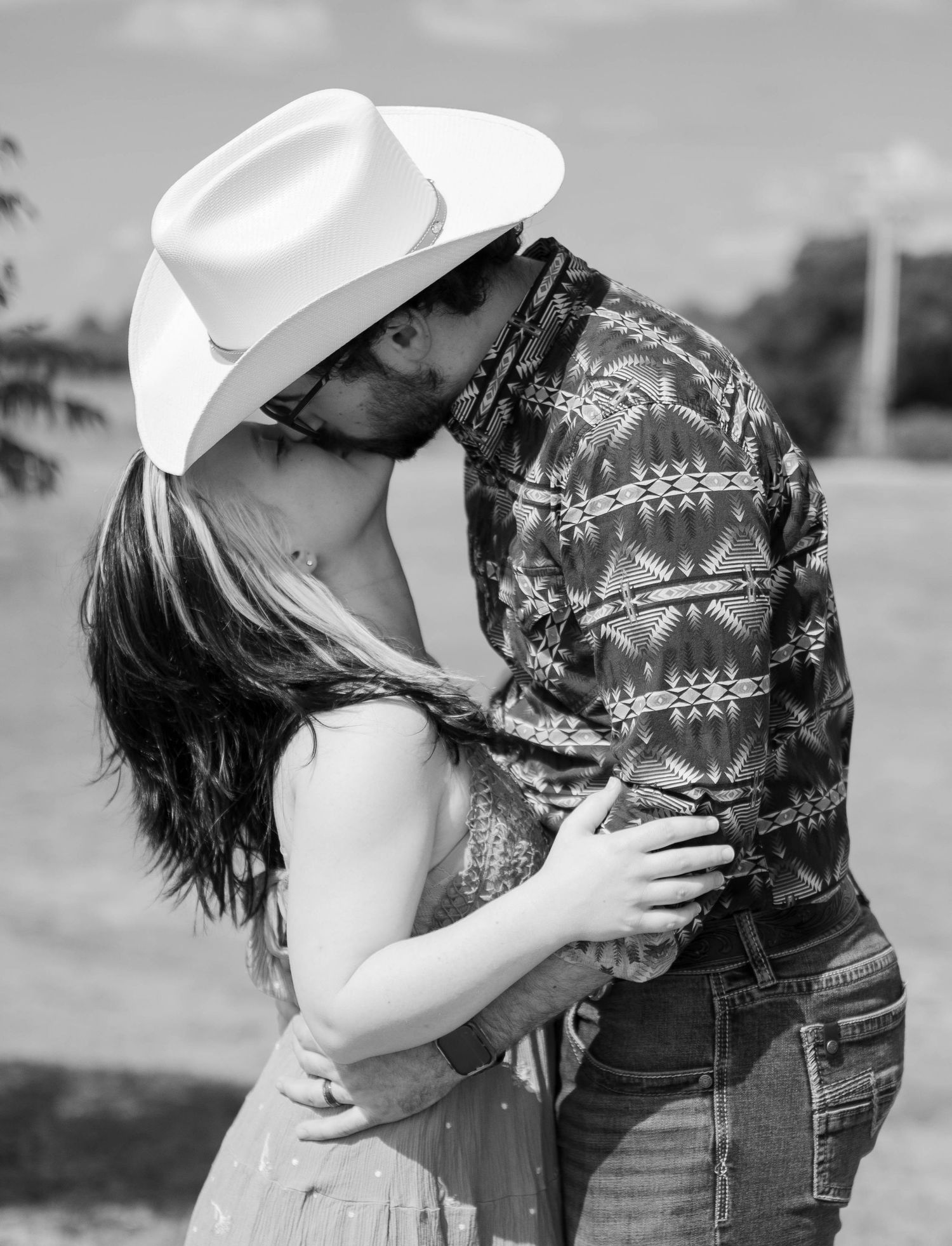 Black and white sequence showing romantic moments between a couple in country western attire.