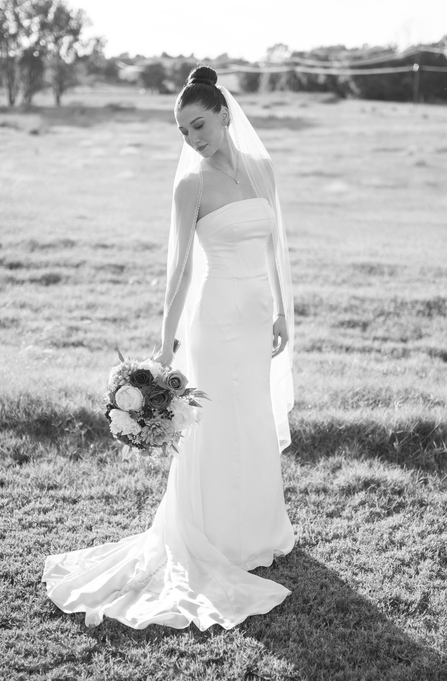 Black and white bridal portraits showing elegant wedding dress details in outdoor setting.