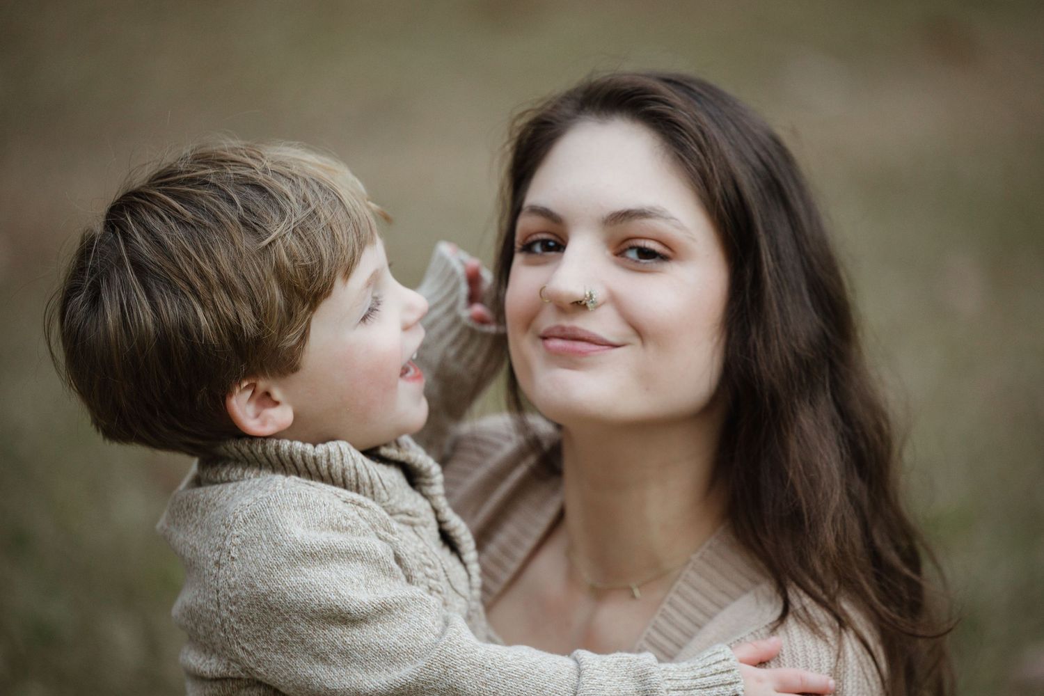 Mother and child share tender moment in soft natural lighting.