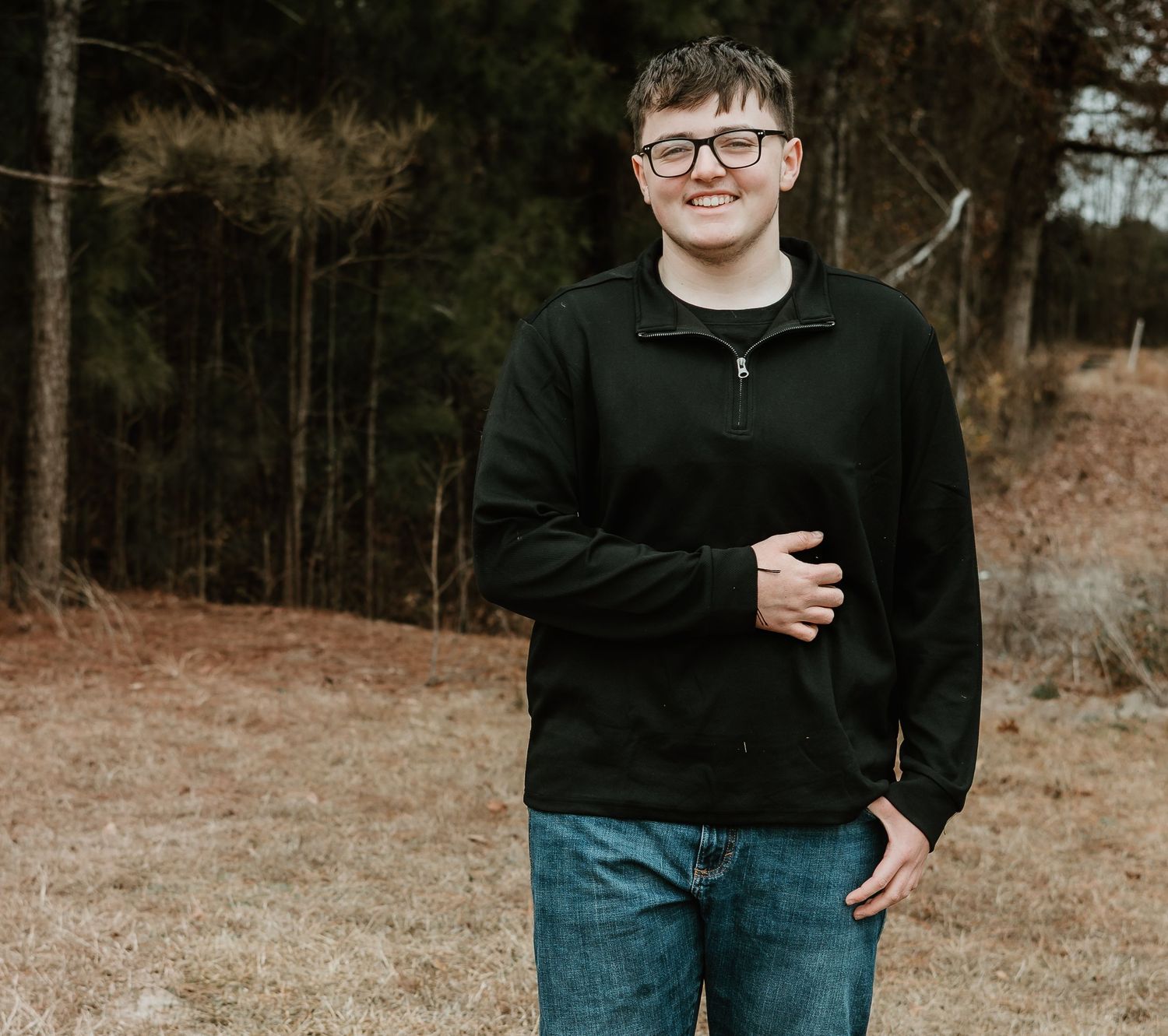 Casual outdoor portrait sequence in natural setting with dark clothing.