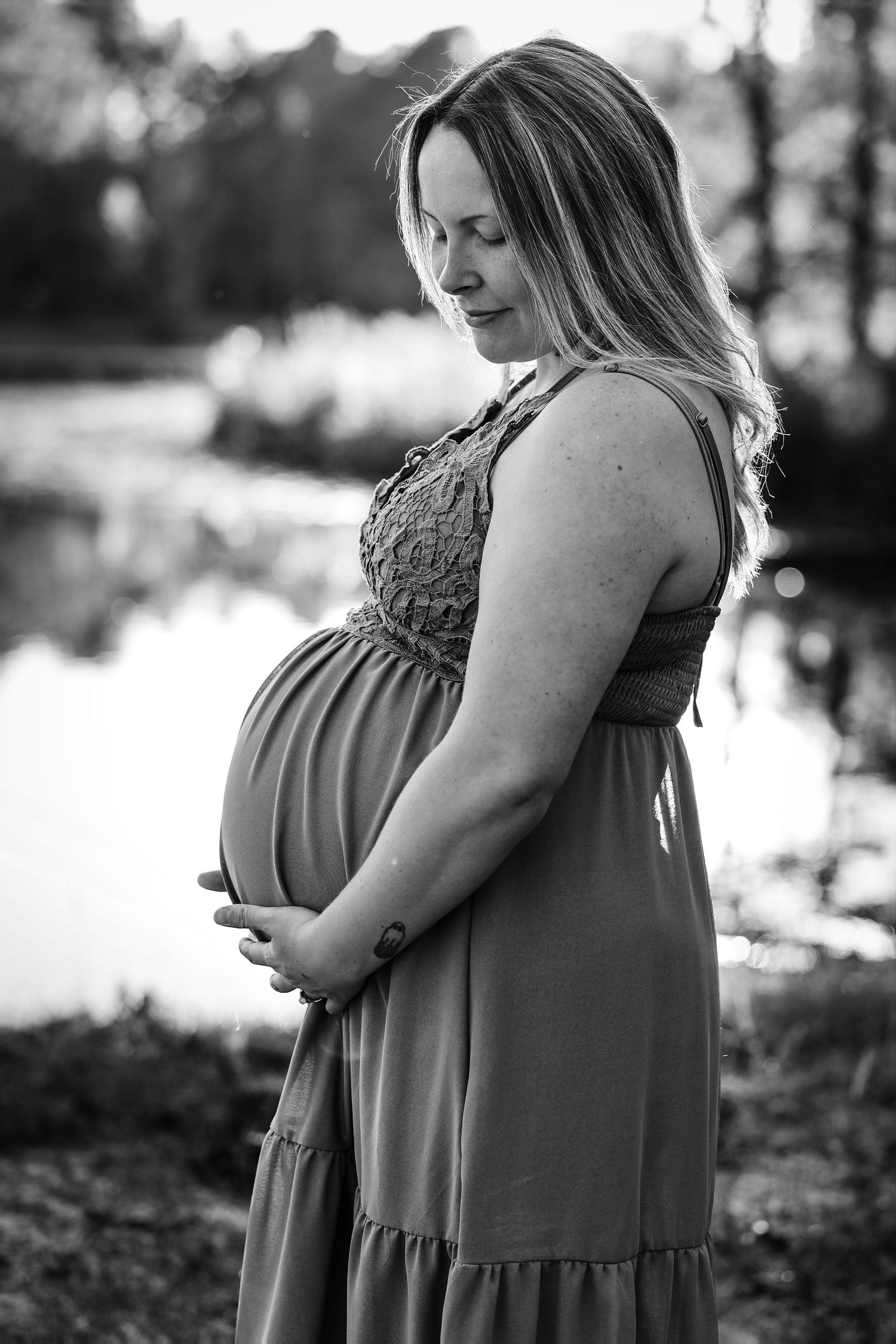 Black and white maternity photography sequence showing pregnant woman in flowing dress outdoors.