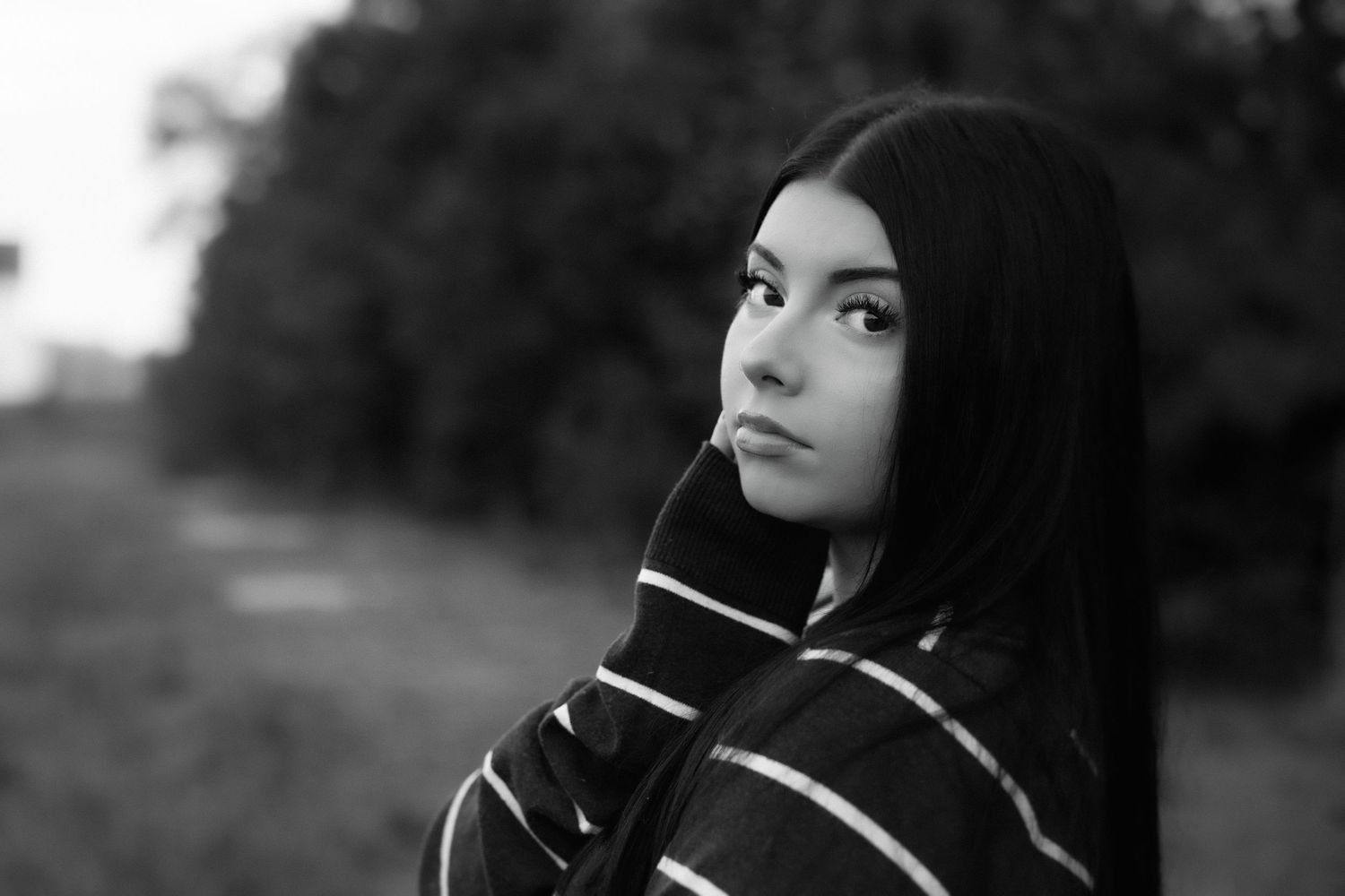 Artistic black and white portrait series with dramatic side lighting.