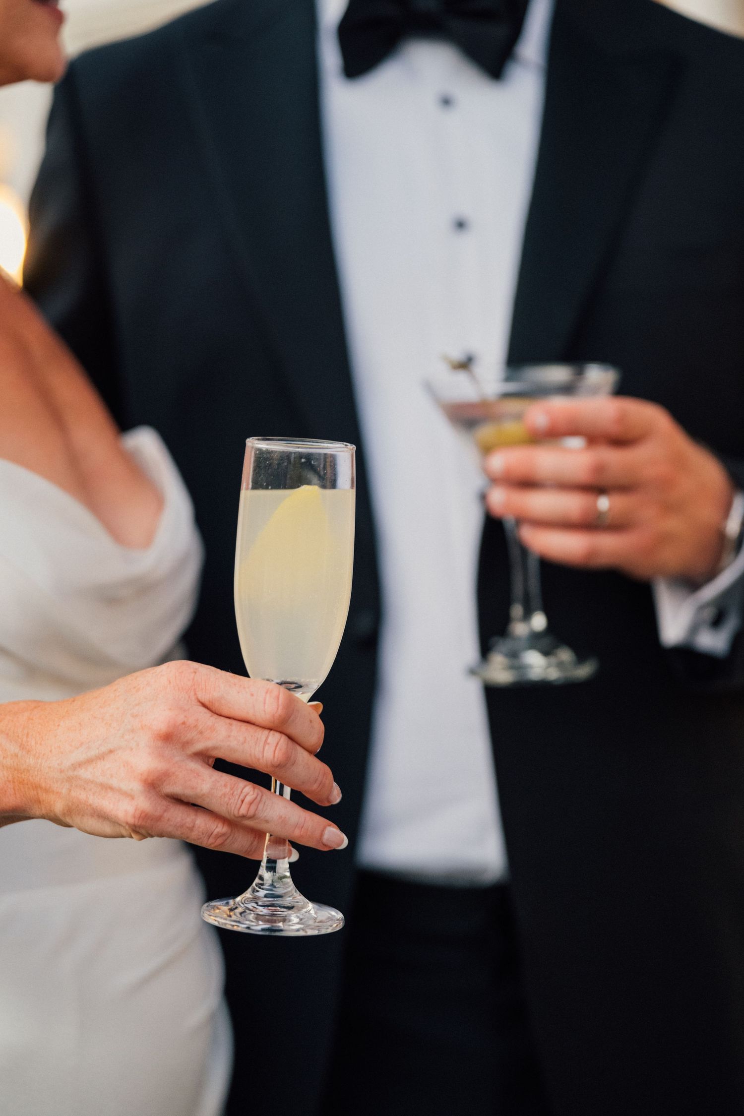 Louis Willard Photo Palm Springs Bride and groom hold champagne flute and martini glass at elegant wedding reception.