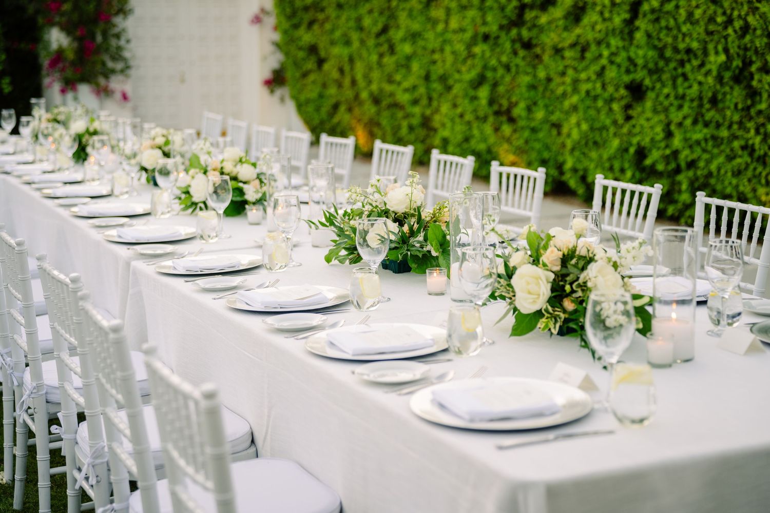 Louis Willard Photo Palm Springs Elegant outdoor wedding reception table with white linens, chiavari chairs, and floral centerpieces.