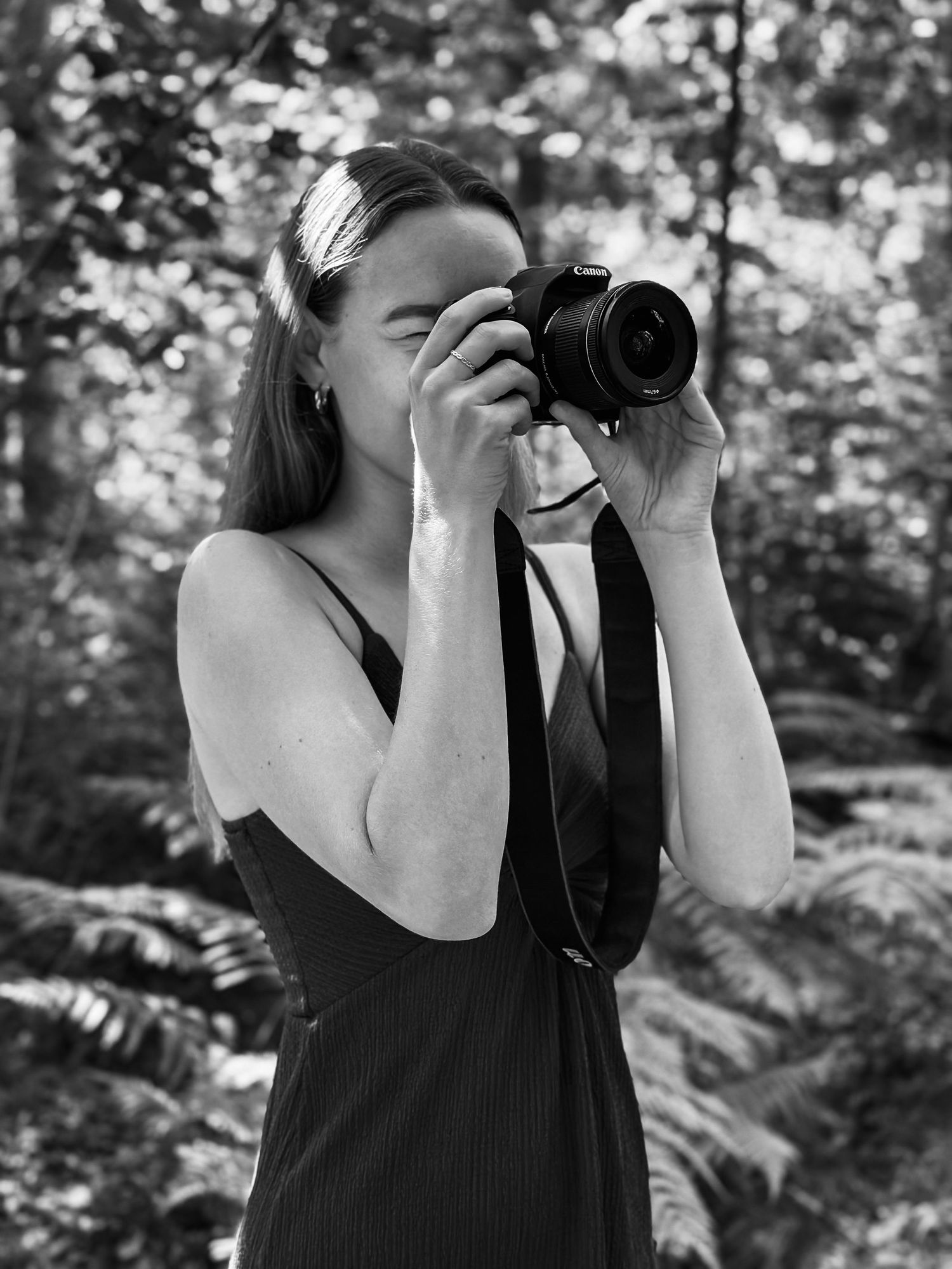en fotograf i Jönköping som håller en kamera i skogen