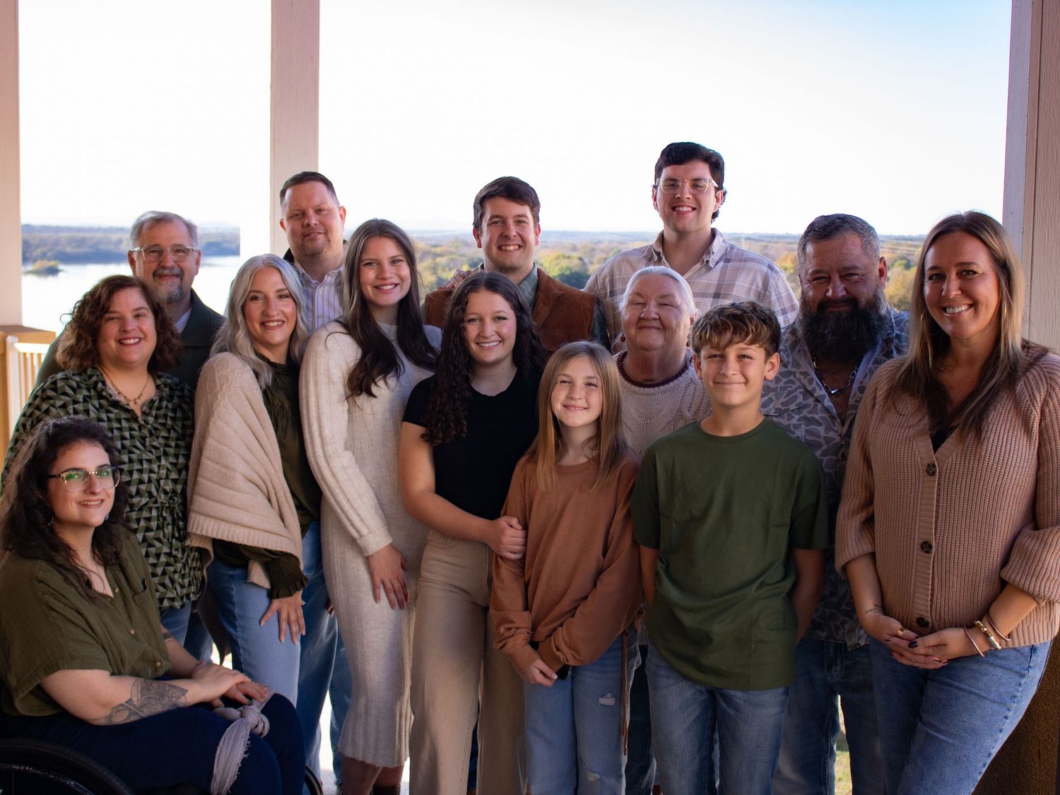 Large family group poses together for a formal indoor portrait session.