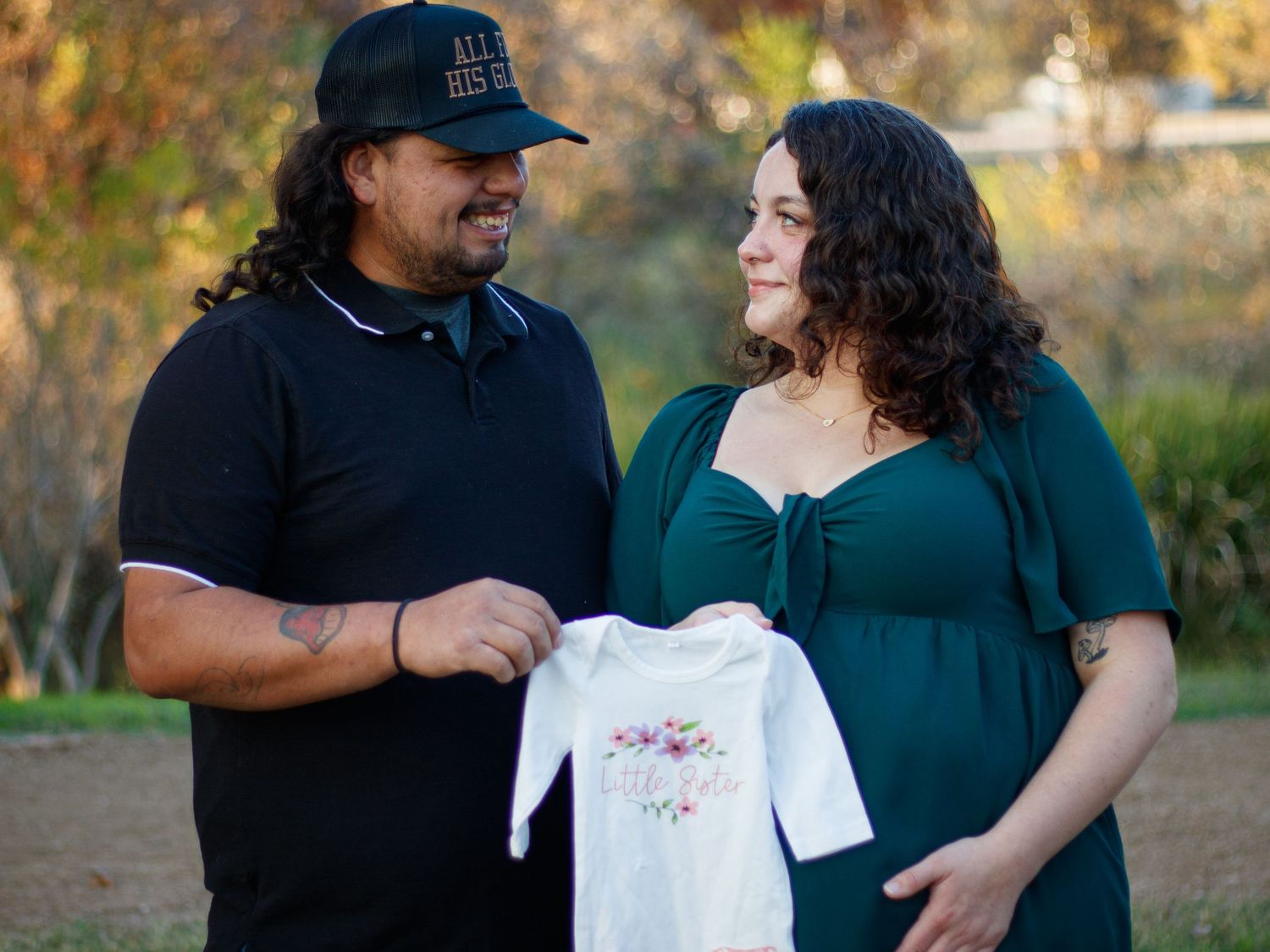 A couple shares tender moments during their casual outdoor maternity photo session.