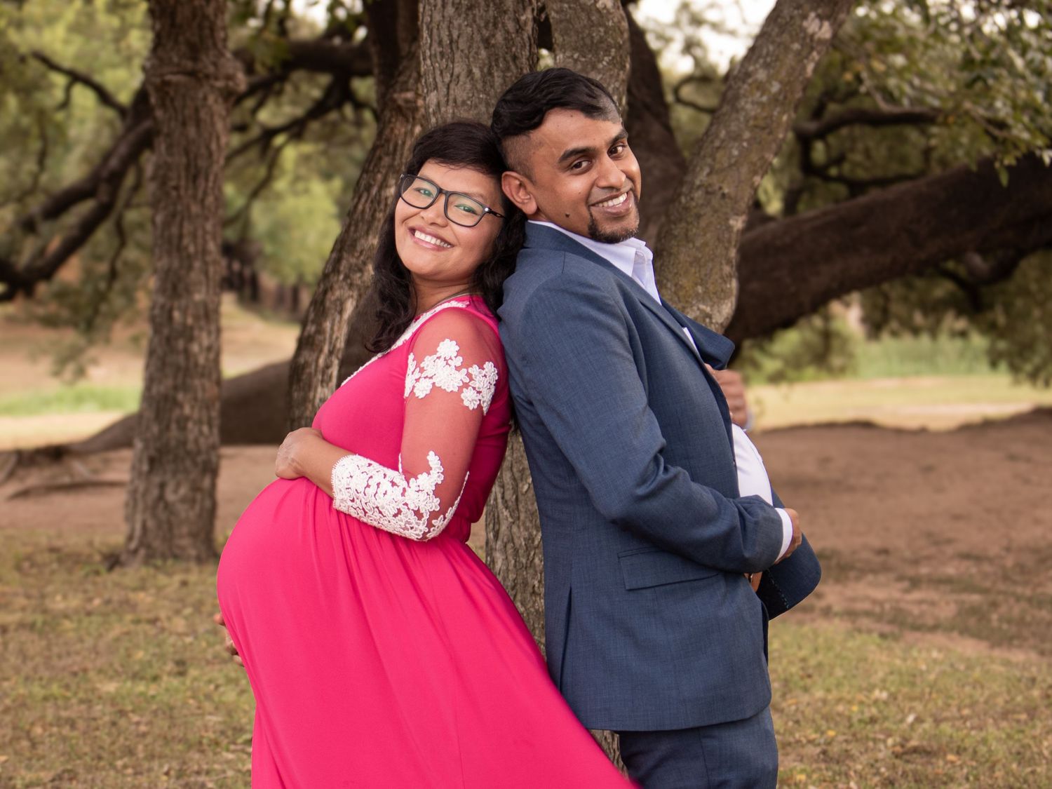 Couple in red and navy outfits share playful moments during their outdoor photo session.