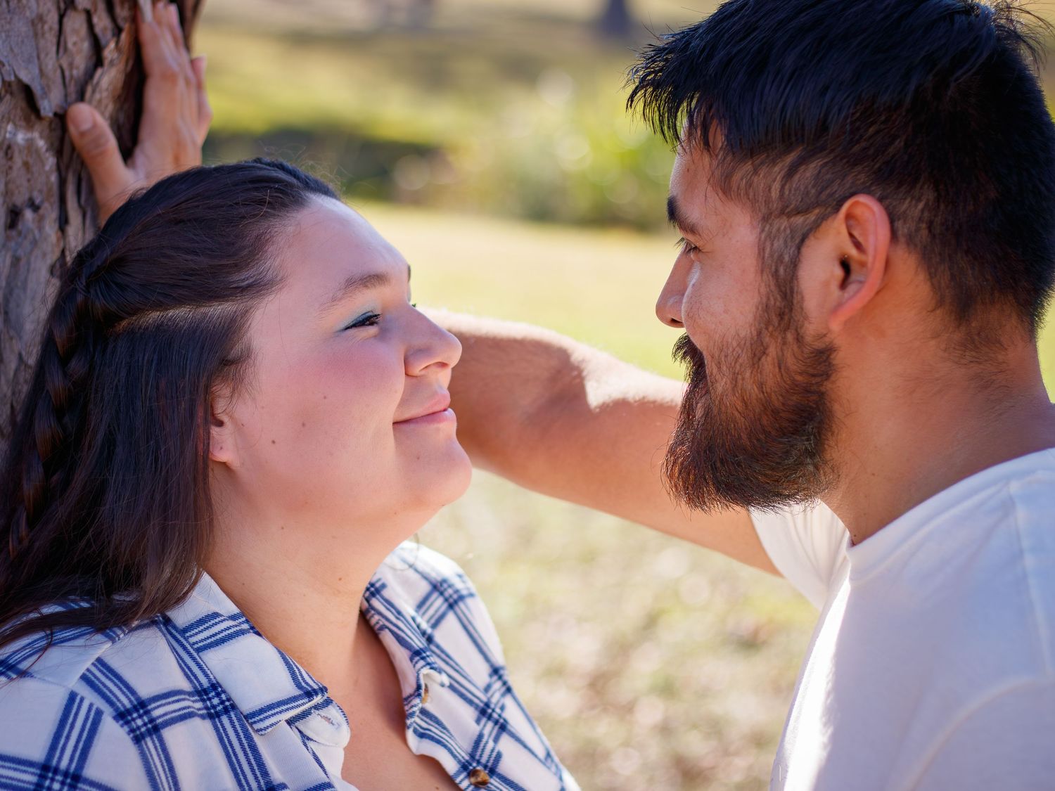 A couple shares intimate moments during a golden hour outdoor photoshoot.