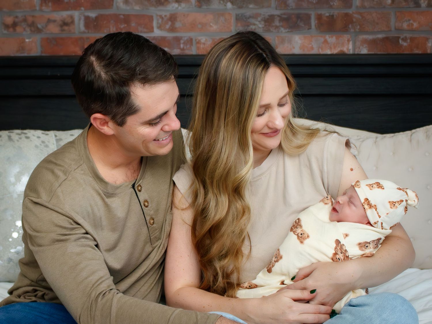 Parents share tender moments with their newborn during an indoor lifestyle session.