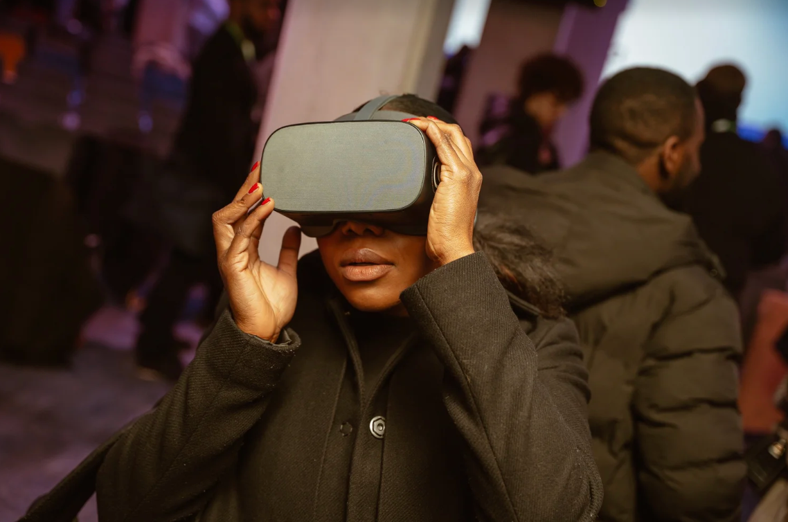 Person experiencing virtual reality with VR headset in dark setting.