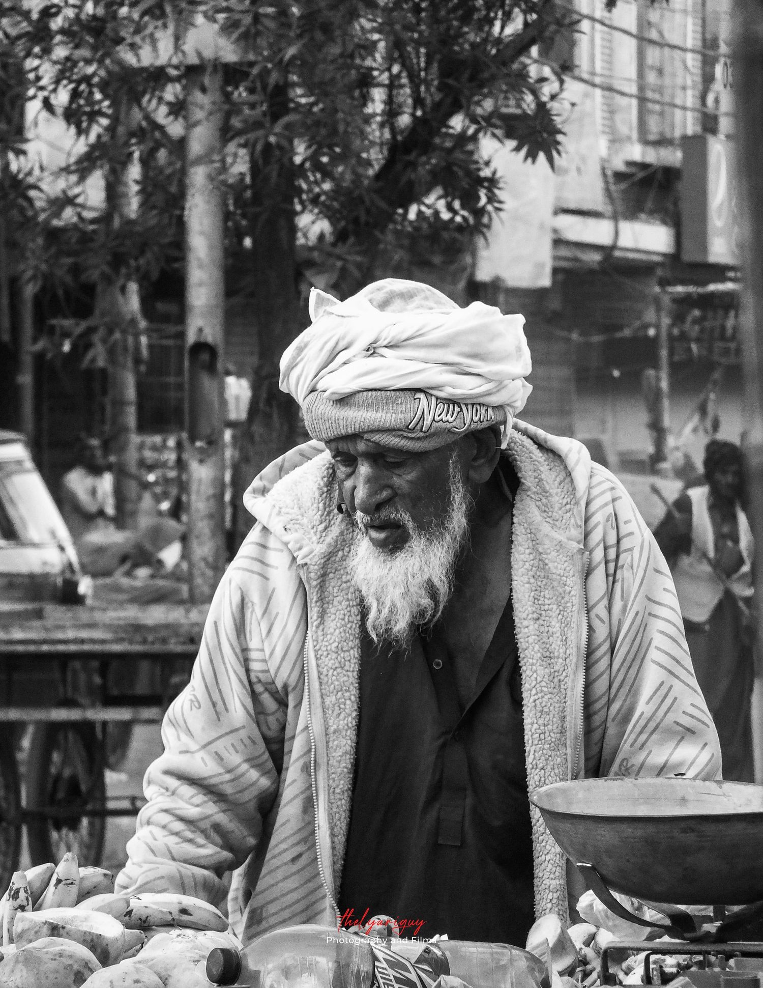 An old man selling fruits in Karachi.